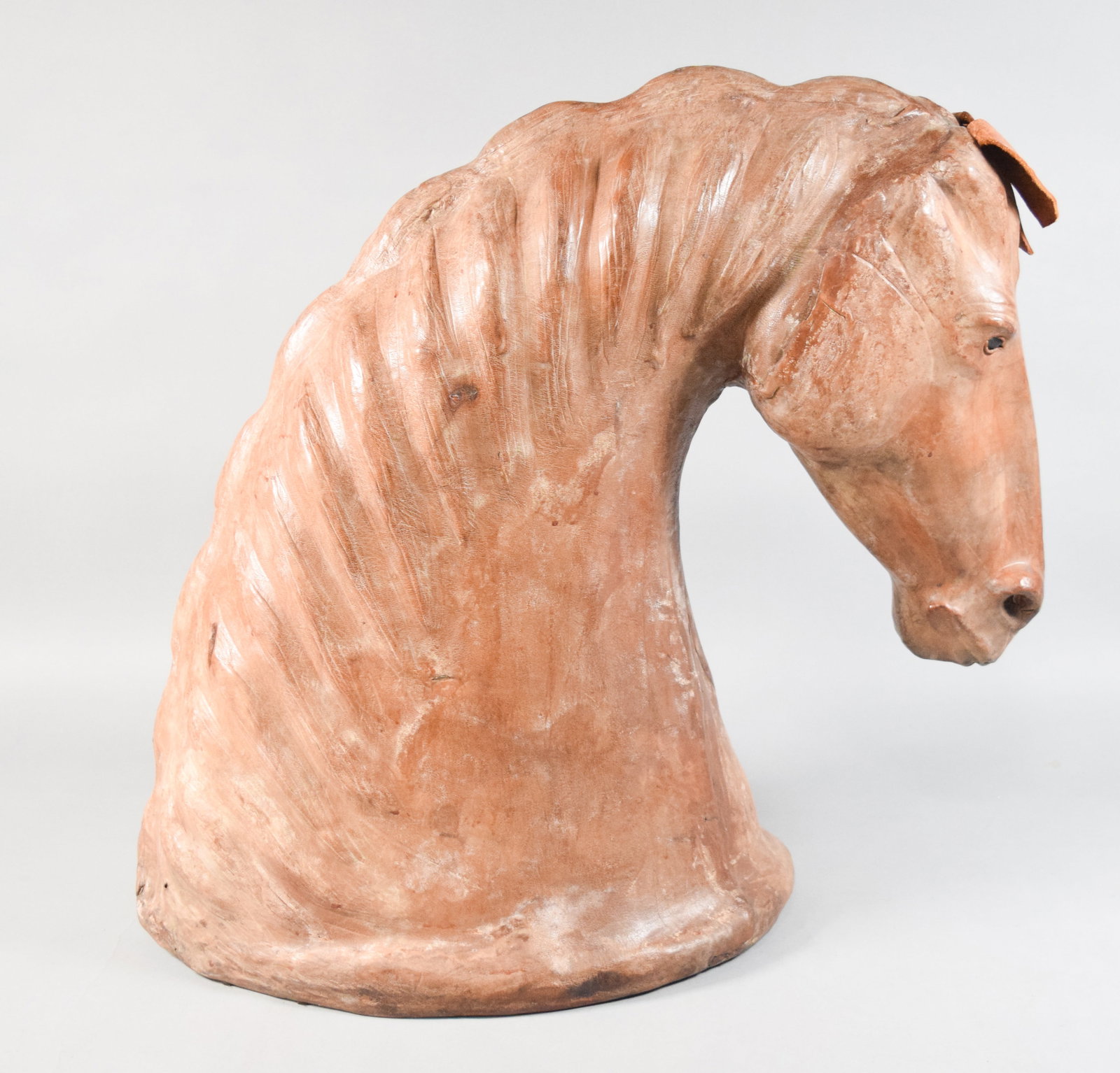 Large Leather-Wrapped Equestrian Horse Head Bust: Large, leather-wrapped equestrian horse head bust. Constructed from multiple shaped leather panels joined over a solid core with two applied leather ears. Mounted on an integrated oval base. Appears u