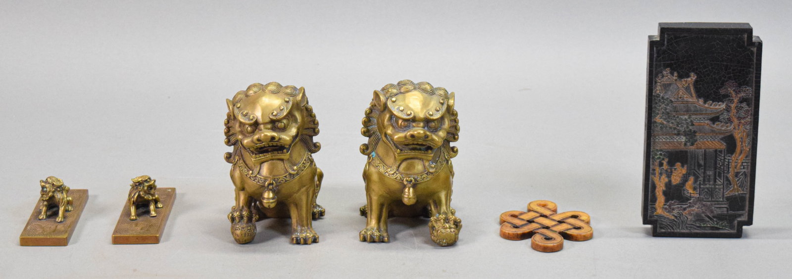 6 Chinese Decorative Items Foo Dogs, Ink Stick: Group of 6 Chinese decorative items, including pair of brass foo dogs, each 5"H x 5"L; ink stick in fitted case, ink 6 3/4"L; hardstone carved knot, 3 7/8" x 3"; pair of brass lion weights, each 4 1/4
