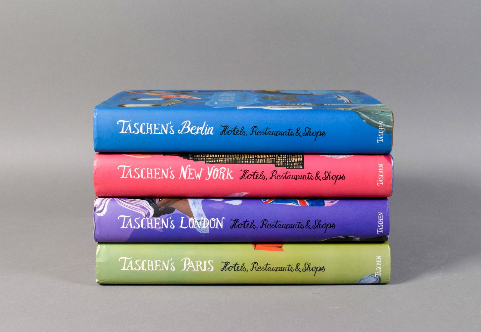 4 Volumes of Taschen's Hotels, Restaurants & Shops: Set of four large-format travel guides from the Hotels, Restaurants & Shops series published by Taschen, including Berlin, New York, London, and Paris. Each volume is bound in publisher's pictoria