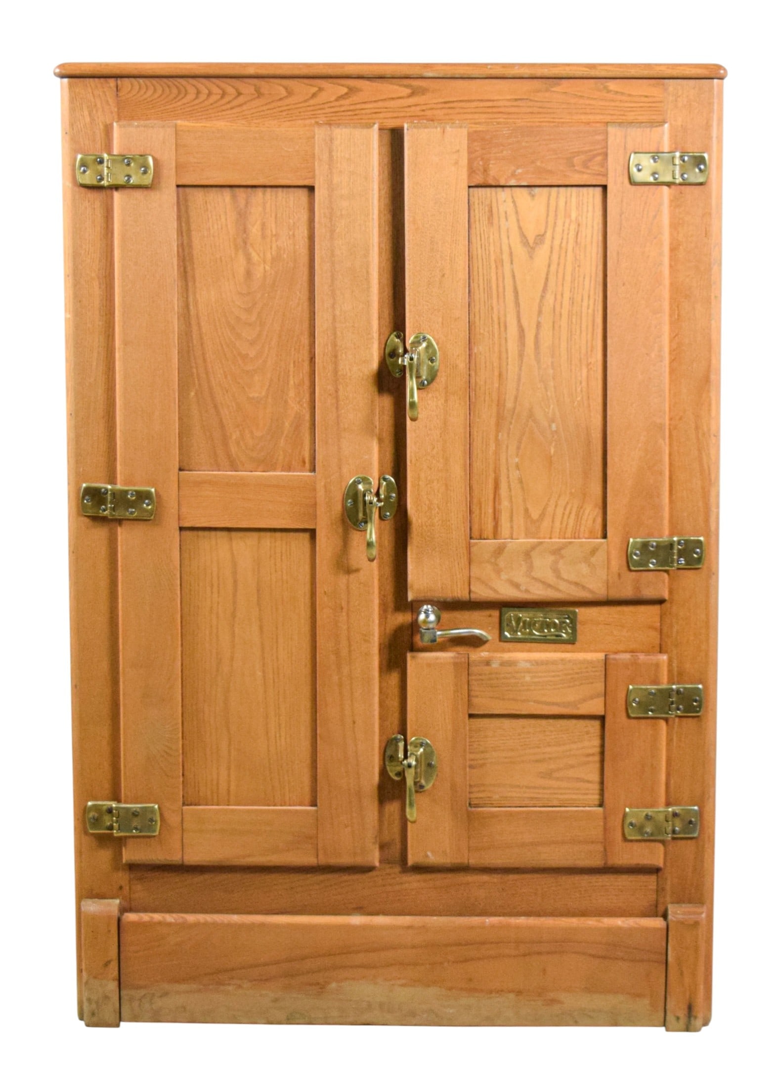 Victor Oak Ice Box: Victor oak ice box. With brass hardware, 3 doors, interior wire shelves, enamel lid. Metal Victor label. 49 1/8"H x 33 1/2"W x 18 1/2"D. Scratches to top, minor scratches throughout, di