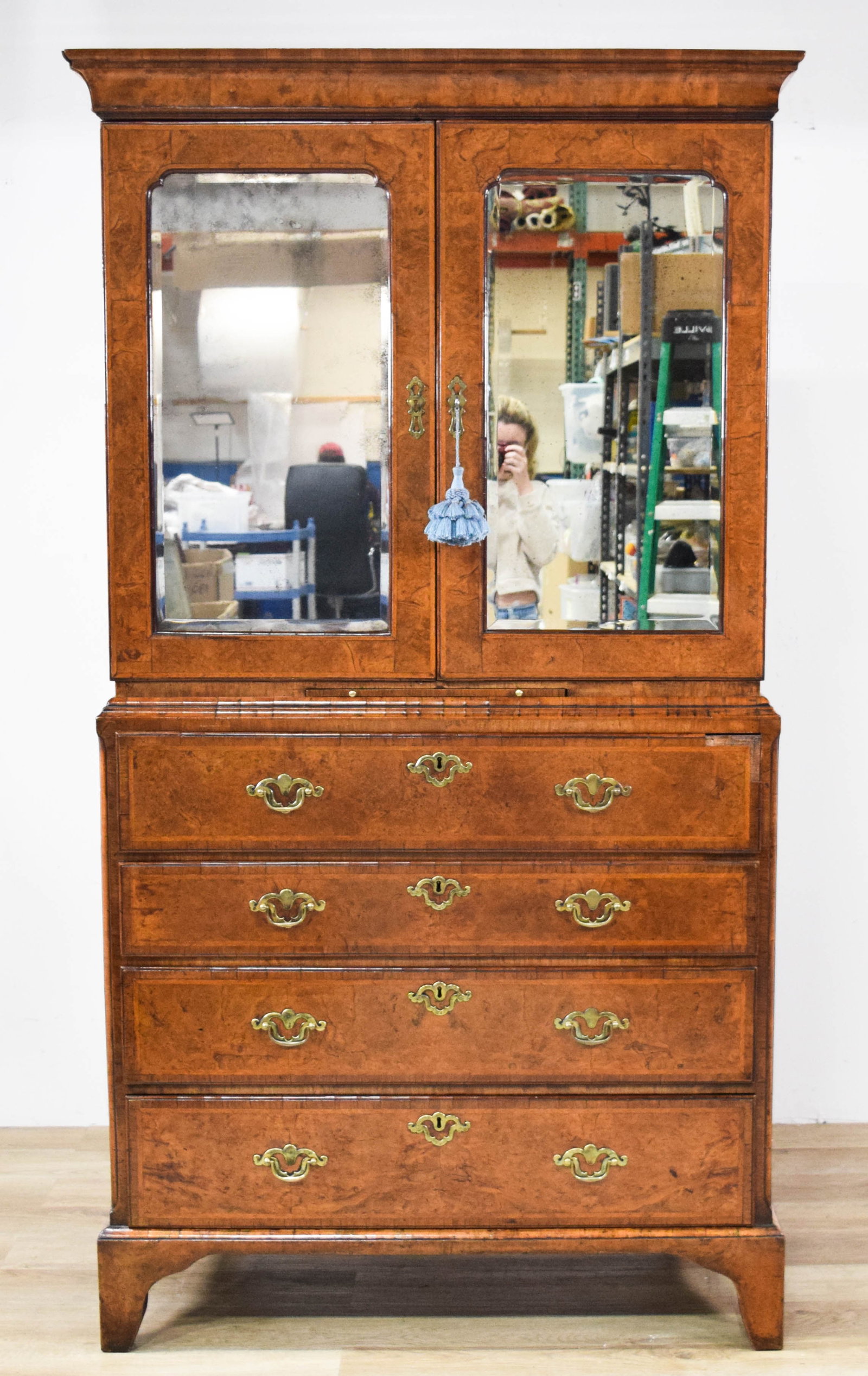William and Mary Style Mirrored Cabinet on Chest: William and Mary style mirrored cabinet on chest. Two sections with burr walnut veneers throughout. Upper section with a molded cornice over a pair of arched mirror panels opening to reveal eight smal