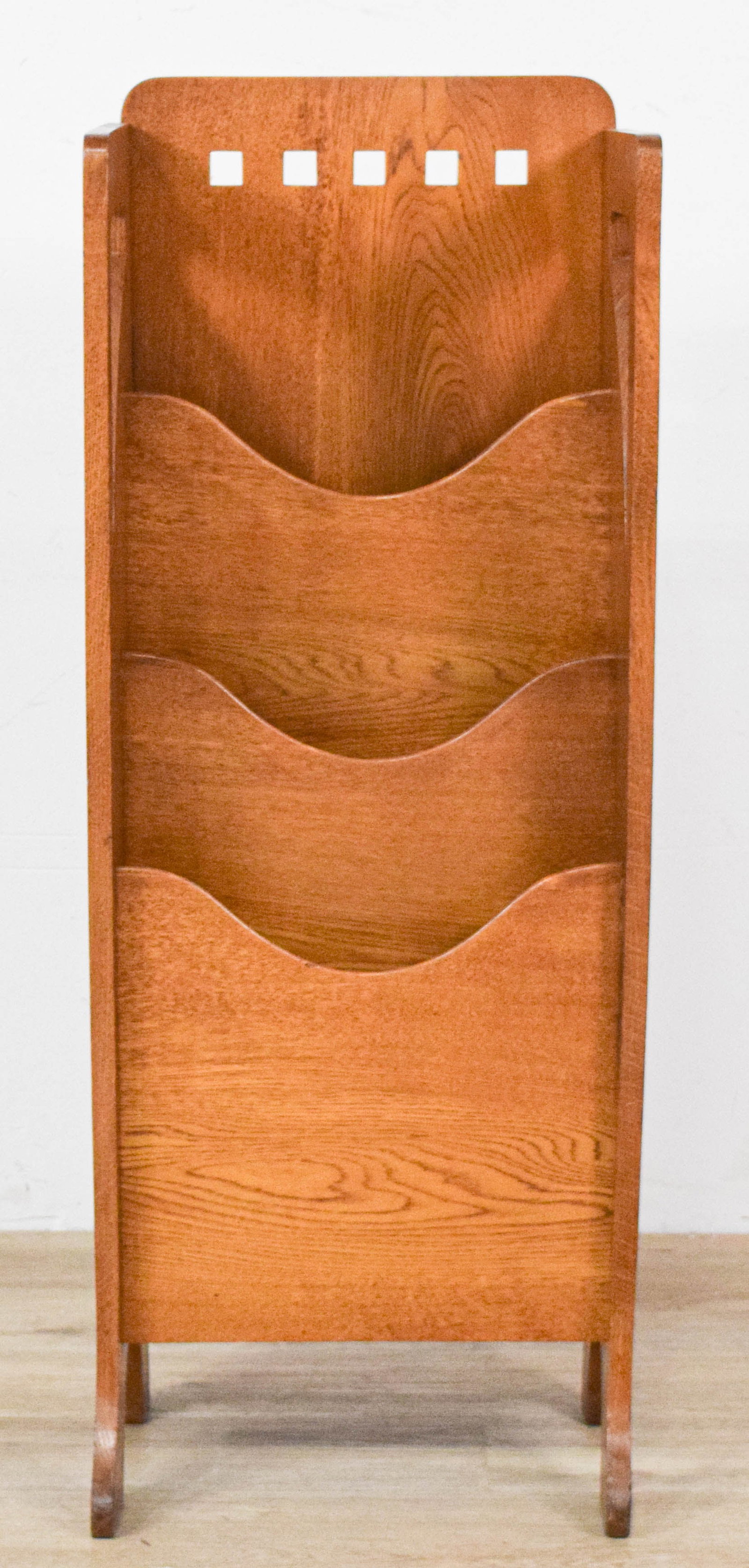 Arts and Crafts Oak Four-Tier Magazine Rack: Arts and Crafts oak four-tier magazine rack. Side panel with integrated handles at the top. Appears unsigned. 38 3/4" H x 15" W x 11" D.