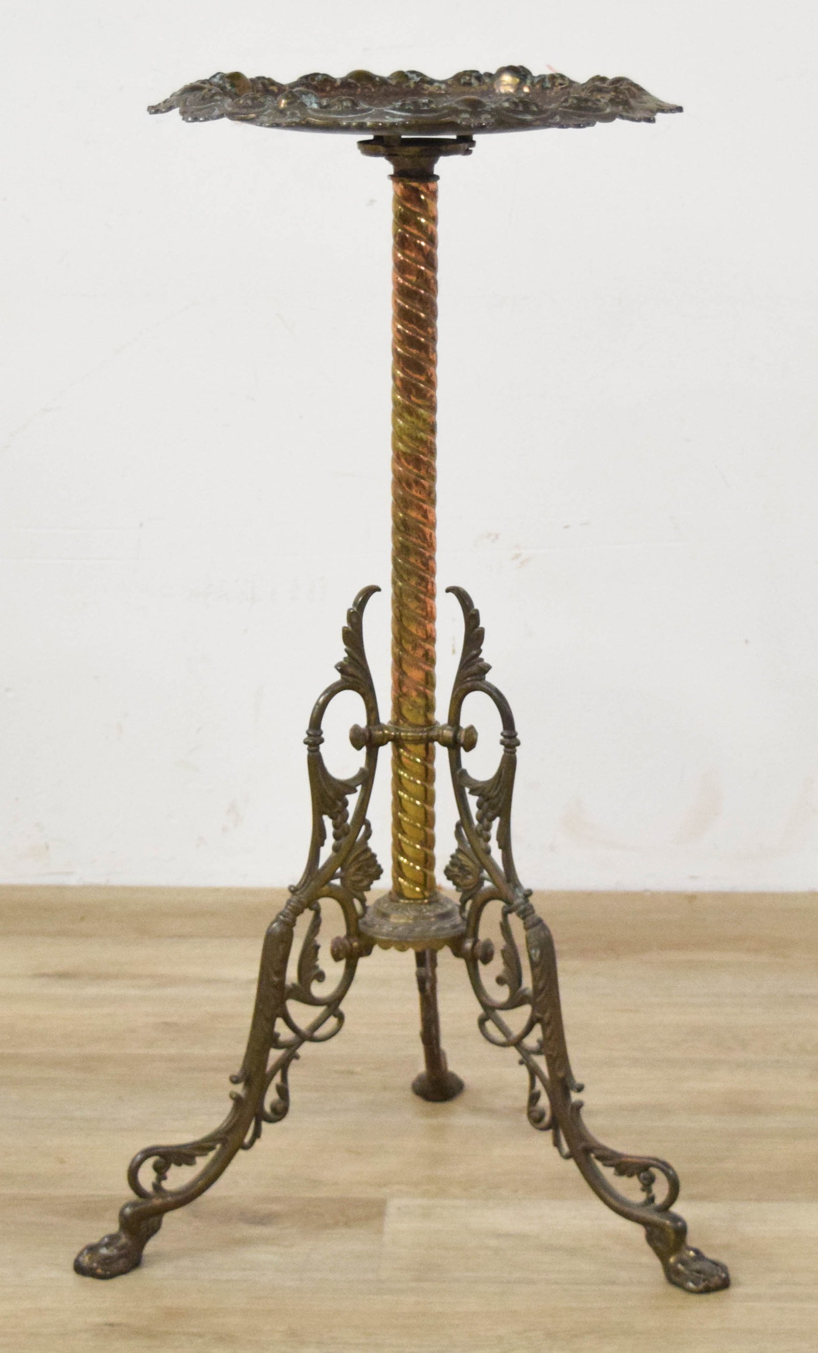 Bradley and Hubbard Twisted Column Pedestal Stand: Bradley and Hubbard pedestal stand with a circular cast metal tray top. Central column with twisted brass and copper rods. Tripod base with paw feet. Marked on the underside of the tray B & H mode