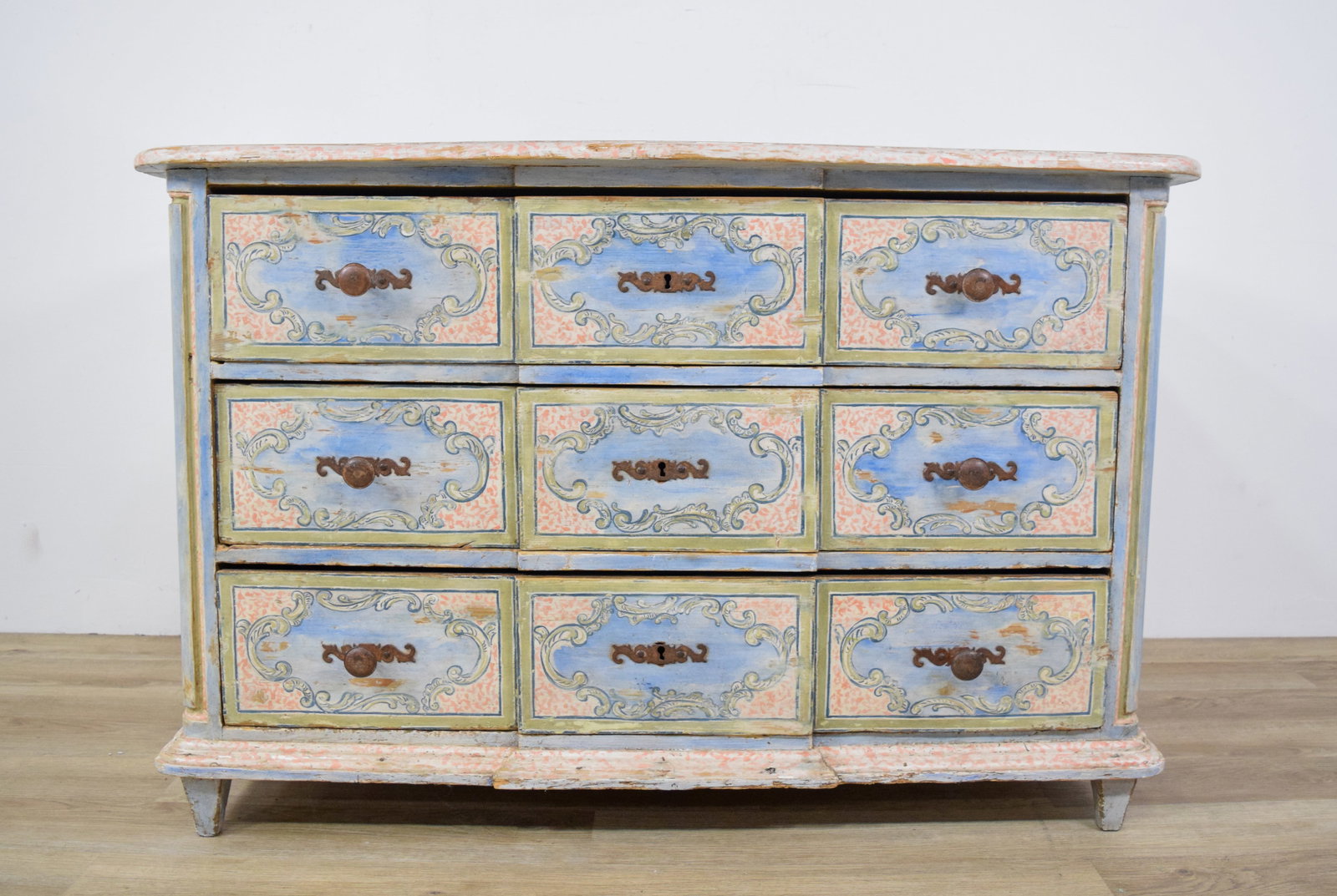 French Provincial Painted Wood Commode: French Provincial painted wood commode with nine drawers. Fitted with cast metal bail handles and three decorative escutcheons. Marked Camard Made in France on reverse. 33 3/4" H x 51" W x 25 1/2" D.