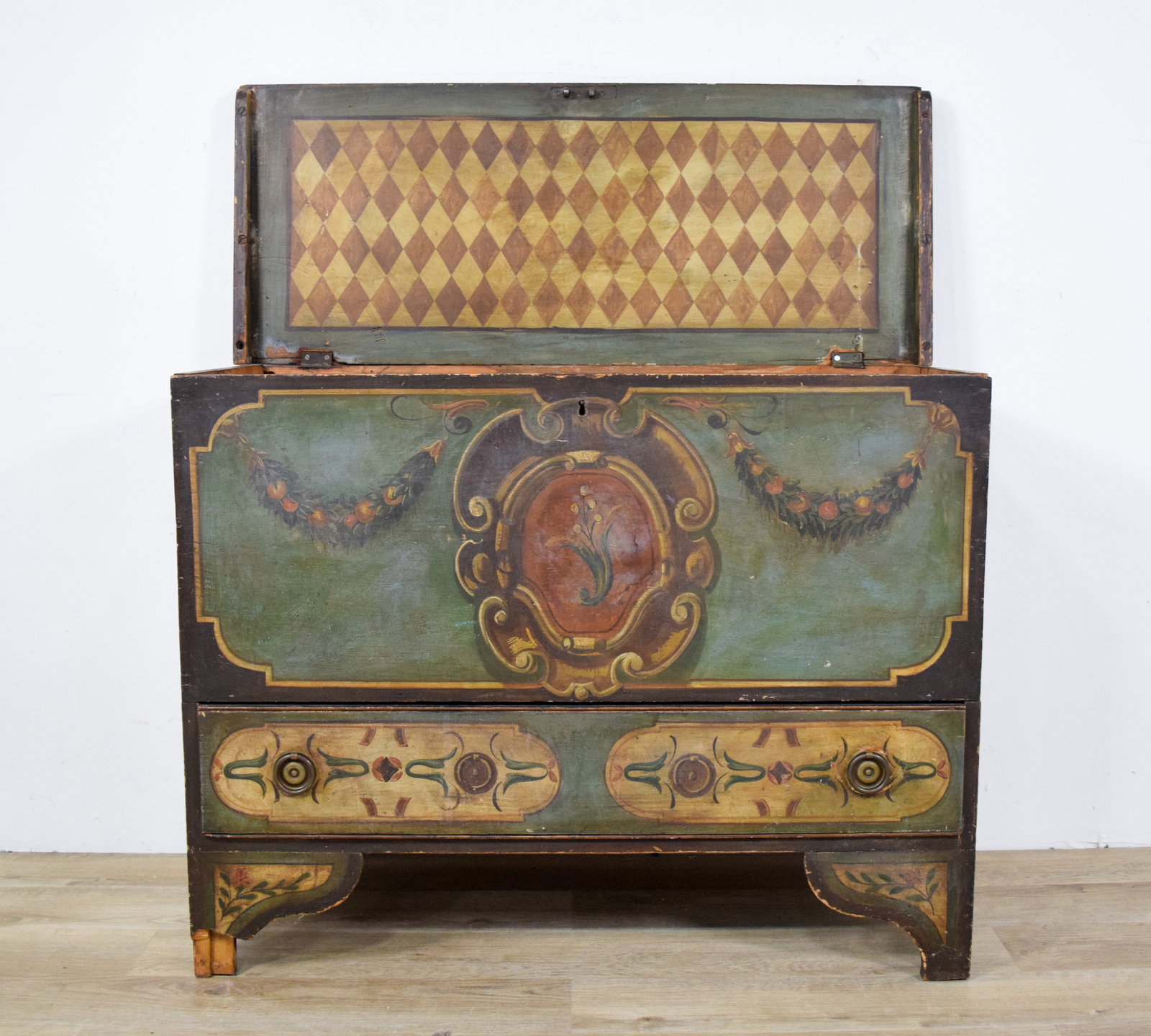 Painted Blanket Chest with Drawer: Hand-painted blanket chest with lower drawer. Underside of lid with hand-painted harlequin diamond pattern. Missing interior till. 33" H x 43" W x 17 1/2" D.