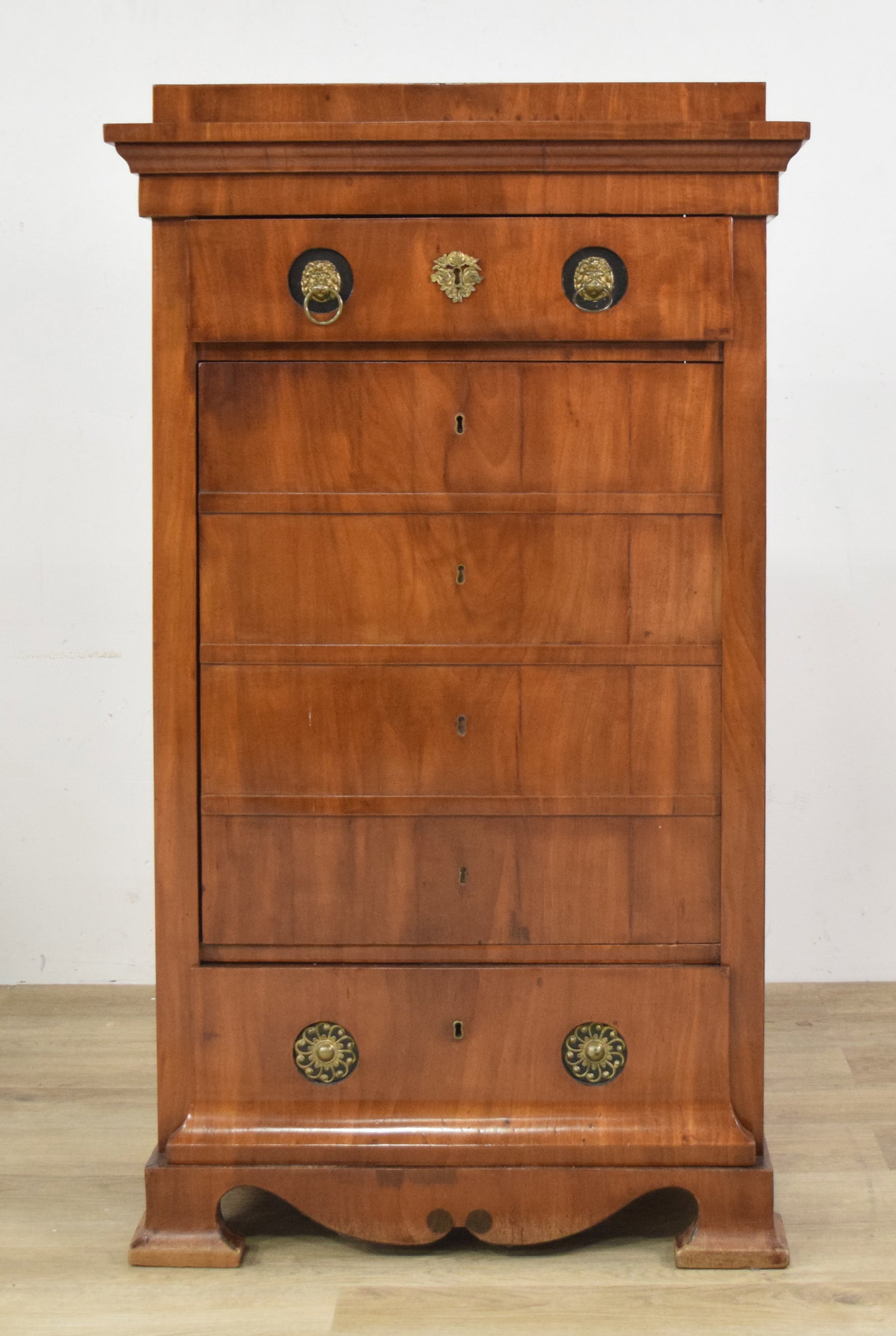 Late 19th Century Biedermeier Style Chiffonier: Late 19th century Biedermeier style chiffonier with six drawers. Constructed with fruitwood veneers, likely cherry, over secondary wood. Top drawer with two lion ring pulls, bottom drawer with decorat