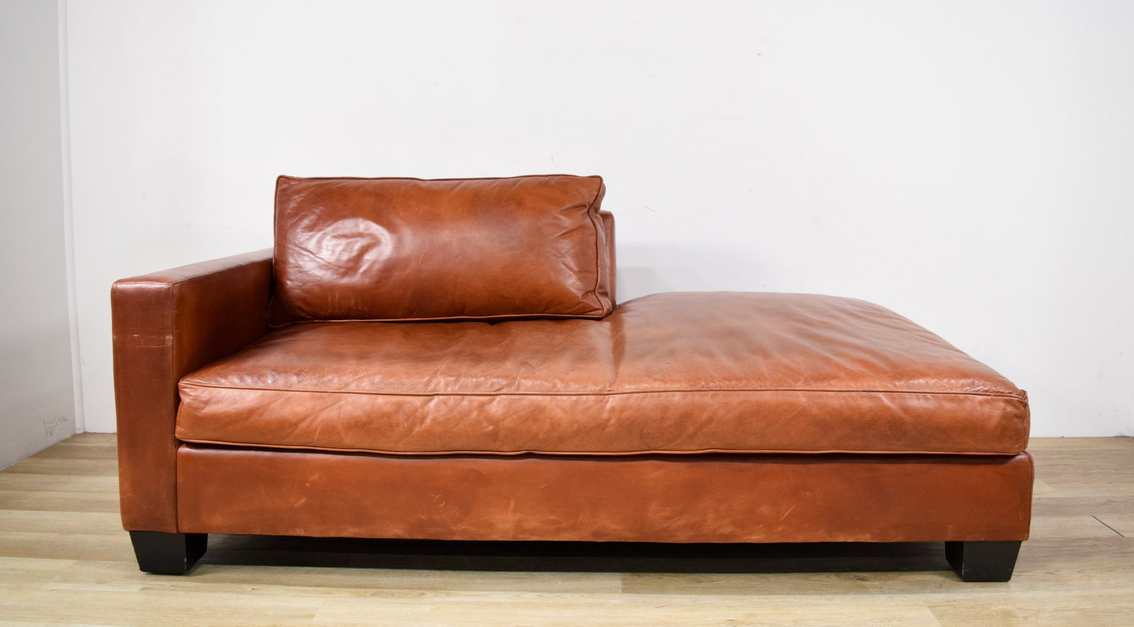 Ralph Lauren Cognac Leather Chaise Longue: Ralph Lauren cognac leather chaise longue. Left-arm facing with a loose back cushion. Ralph Lauren fabric label on the seat lining. 31" H x 76" L x 38" D.