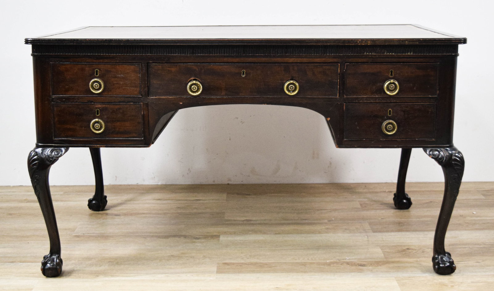 Victorian Chippendale Style Writing Desk: Victorian Chippendale style kneehole writing desk. Carved cabriole legs on ball-and-claw feet. Leather inlaid top. Five drawers on front and back of desk with pull-out writing slide on front. One draw