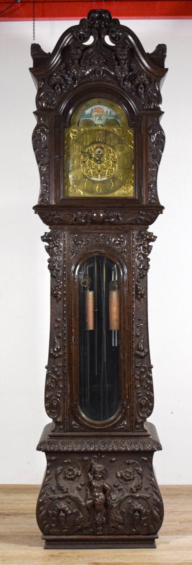 R.J. Horner Carved Grandfather Clock: R.J. Horner heavily carved mahogany grandfather clock. Dial signed R.J. Horner & Co. New York and Elliott London, with scene of house in landscape above. Carved mahogany case with carvings of grif