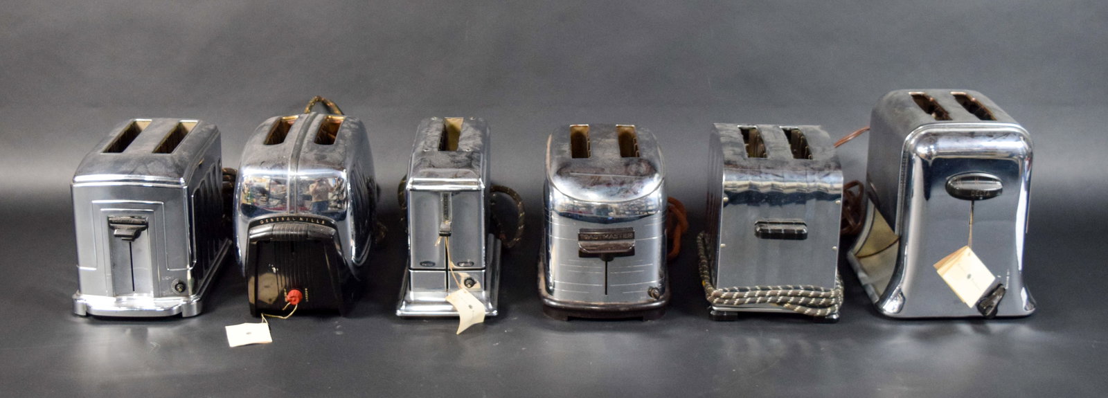 6 Vintage Electric Toasters by General Mills, Toastmaster, and Delta: Six vintage electric toasters from American manufacturers including General Mills, Toastmaster, and Delta, dating from the 1930s through the 1950s. Mainly constructed with chrome-plated metal frames a