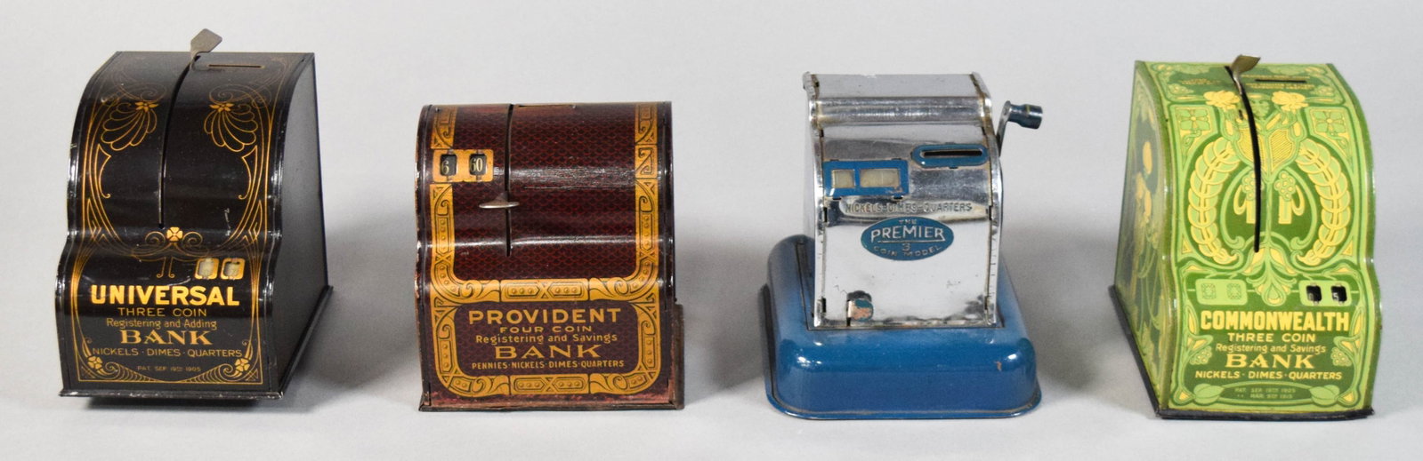 Group of 4 Vintage Mechanical Coin Banks: Group of four vintage mechanical registering coin banks constructed from lithographed tin and plated metal. Includes a 1905 Universal Three Coin Registering and Adding Bank by Shonk of Chicago; a 1913