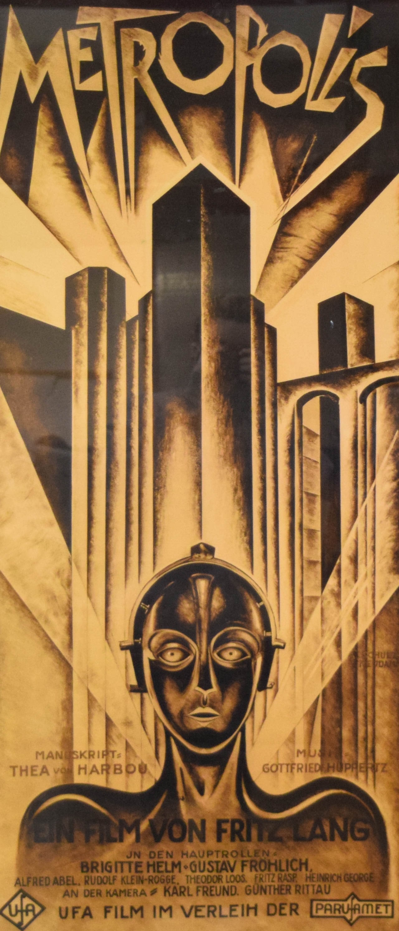 After Schulz Neudam Metropolis Reproduction Movie Poster: Reproduction Metropolis movie poster featuring the Art Deco illustration for the 1927 film. Artwork after Schulz Neudam. 40 1/4" x 19 3/4" with frame.