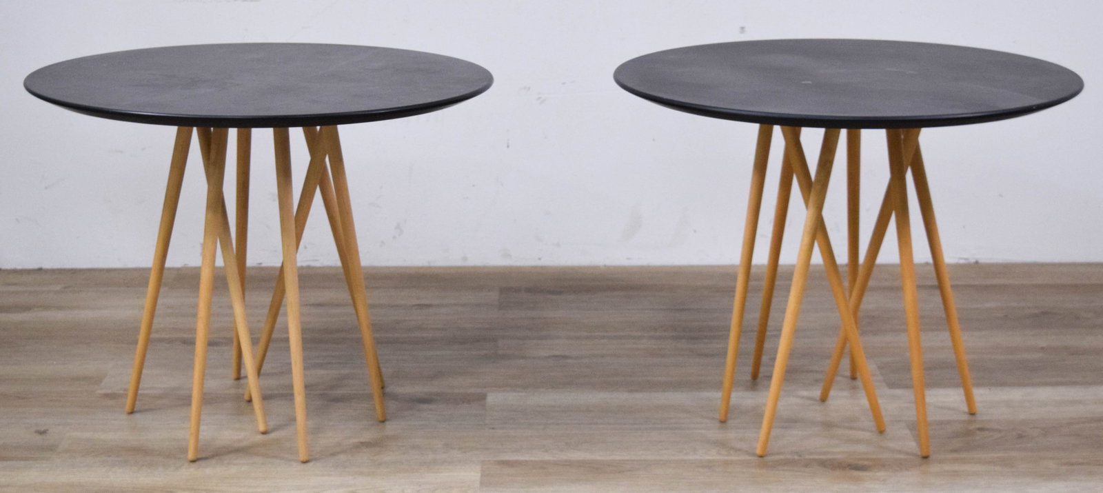 Pair of Contemporary Side Tables with Tapered Spindle Bases: Pair of contemporary accent tables with matte black circular tops supported by six tapered wood spindle legs. Both appear unsigned. 20 1/4" H x 26" diameter.