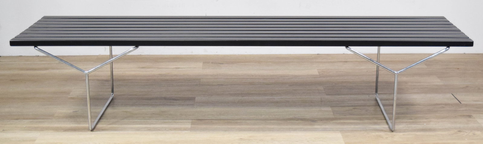 MCM Black Slatted Platform Bench Chrome Base: Mid-Century Modern black slatted platform bench with V-shaped chrome-plated bases. 15" H x 72" W x 18 1/4" D.