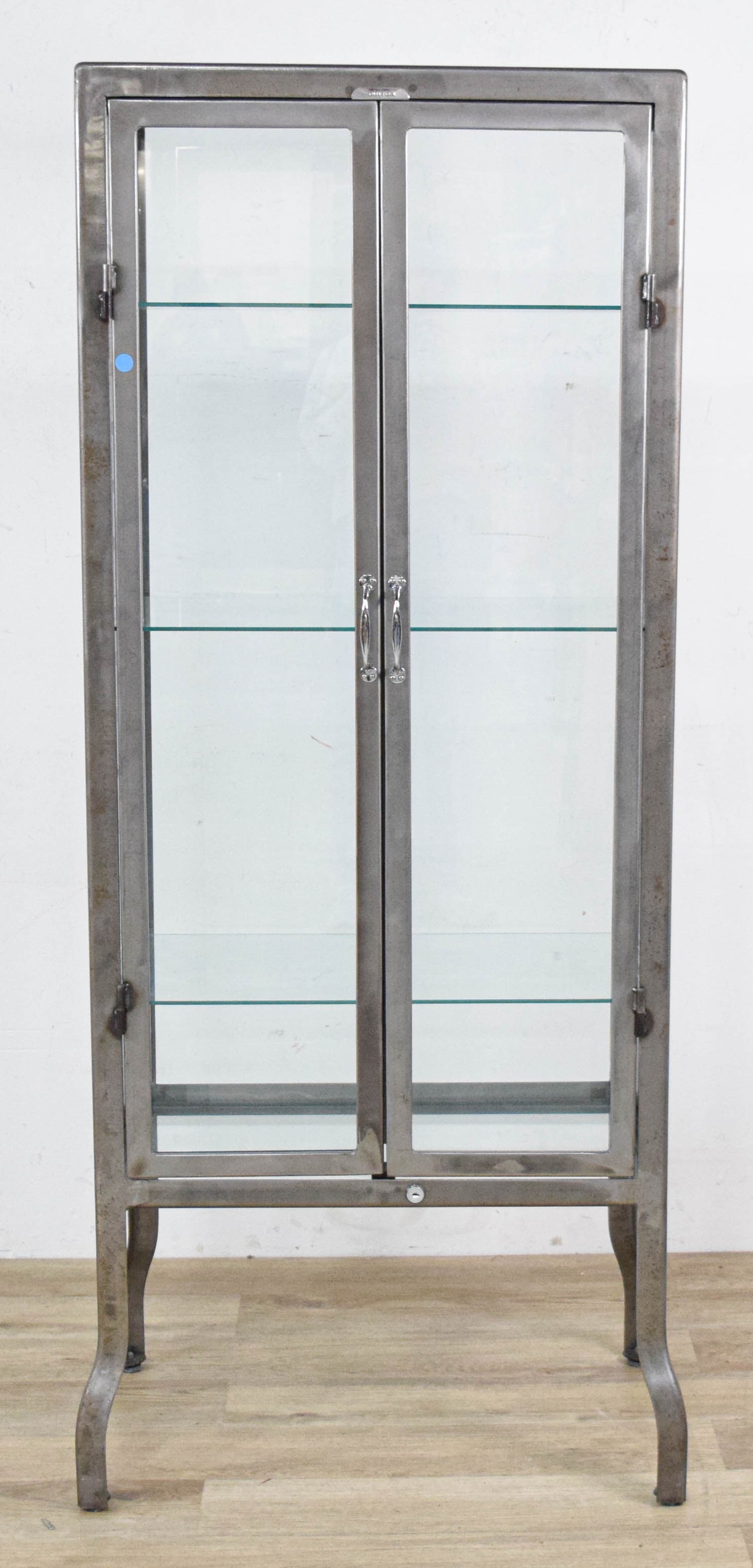 Christian Audigier Dulton Steel and Glass Display Cabinet: Christian Audigier Dulton industrial display cabinet or vitrine with two glass doors and adjustable glass shelves. Missing key. 63 1/2" H x 27 1/2" W x 17 1/2" D.