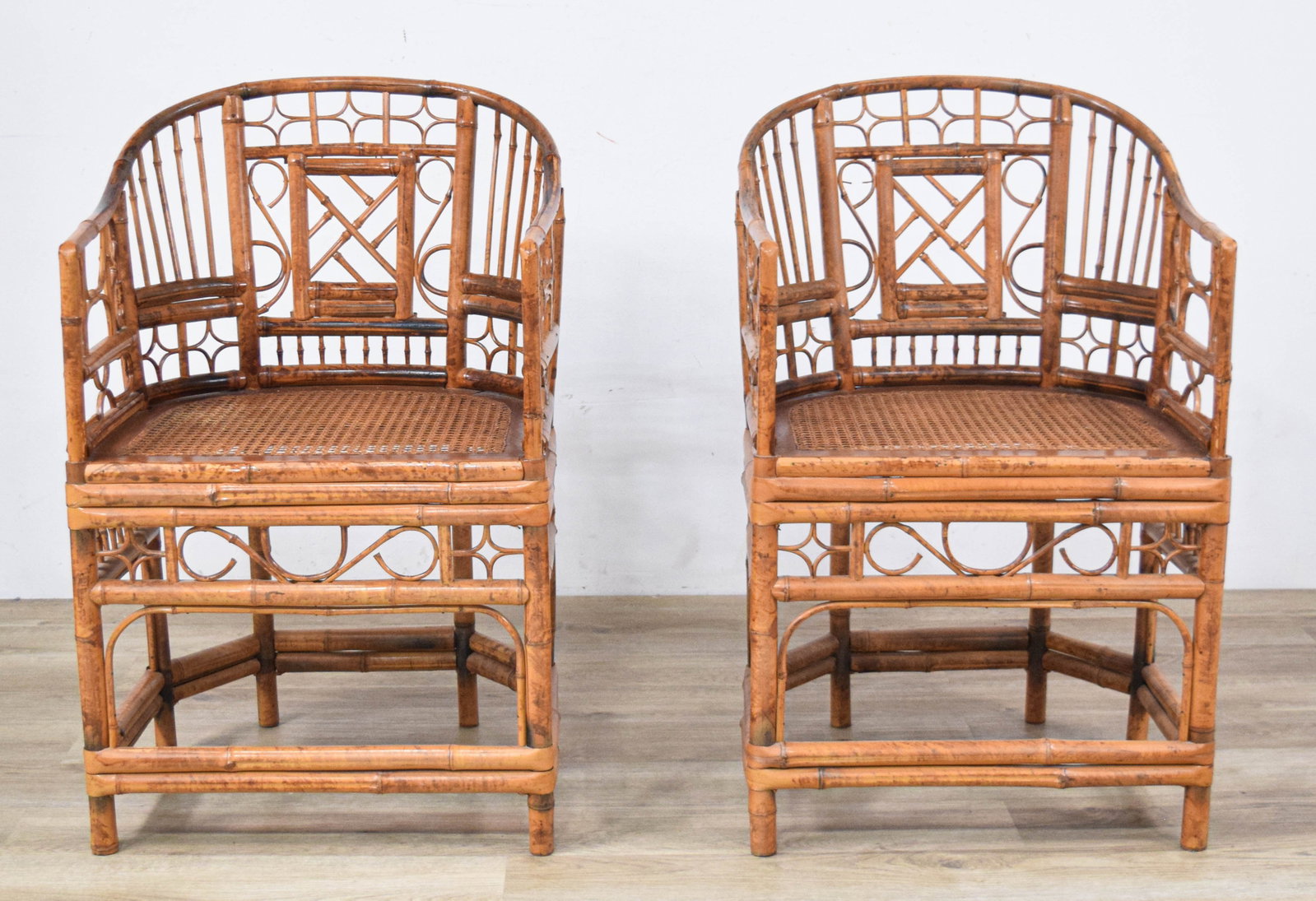 Pair of Faux Bamboo Armchairs with Caned Seats: Pair of Chinoiserie-style faux bamboo armchairs with caned seats, late 20th century. 35 3/4" H x 21 1/2" W x 20" D.