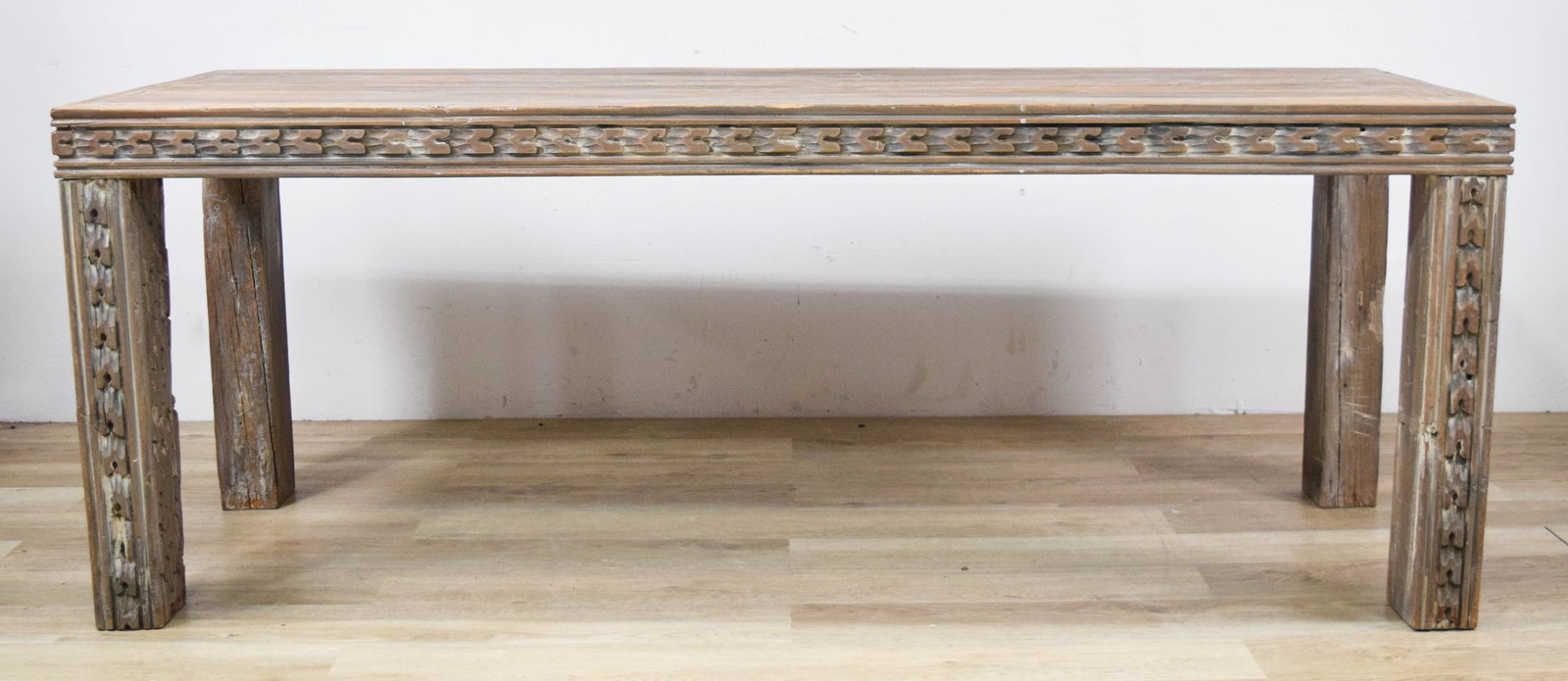 Large Primitive Chip-Carved Solid Wood Dining Table: Large primitive chip-carved dining table. Solid wood with a gray-washed, weathered finish. Rectangular block legs with carved detailing. 29" H x 76" L x 28" W.