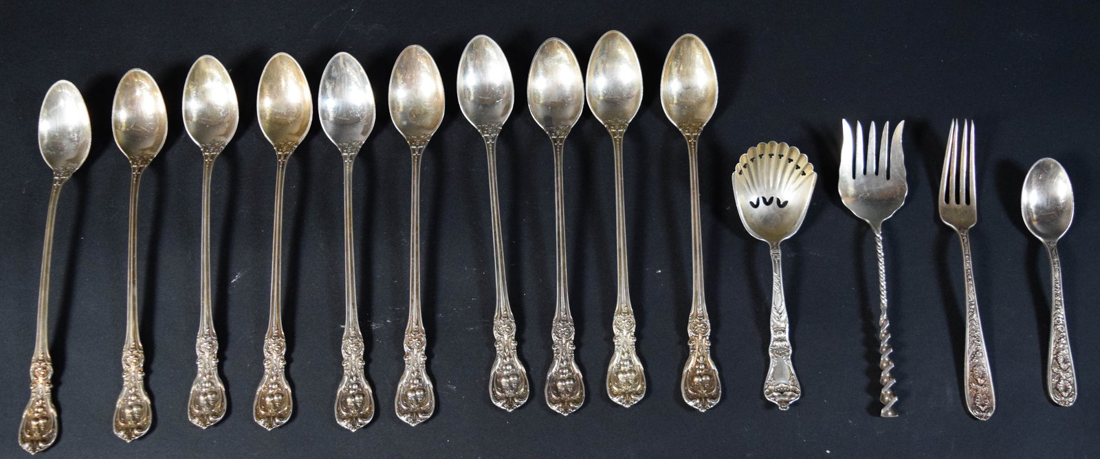 14 Manchester Silver Co Sterling Flatware Pieces Southern Rose: 14 pieces of sterling silver flatware in the Southern Rose pattern by Manchester Silver Co. Includes several iced tea spoons, one pierced shell-form spoon, one meat fork, one luncheon fork, and one te