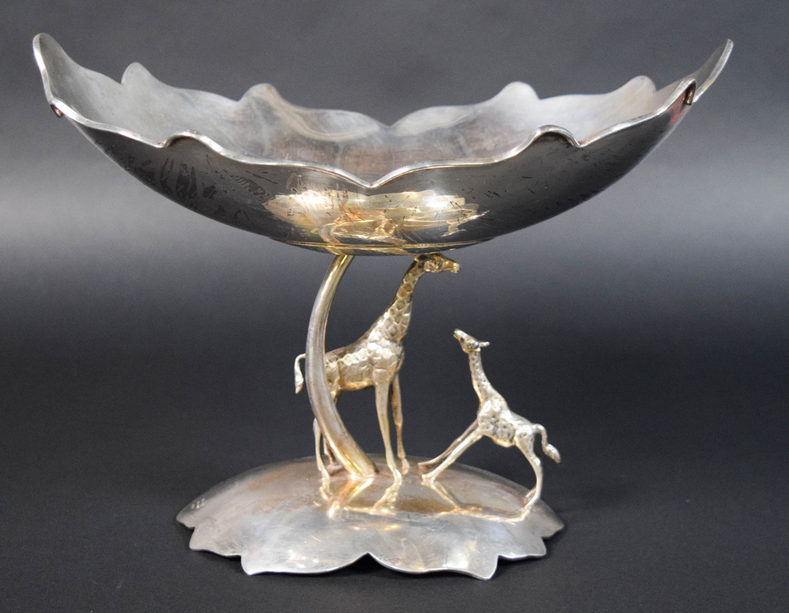 Cartier Sterling Silver Animalier Giraffe Centerpiece Bowl: Cartier sterling silver footed giraffe centerpiece bowl. Underside of the base stamped 925/1000, Sterling, Cartier. 708 grams. 9" H x 12" W x 8" D.