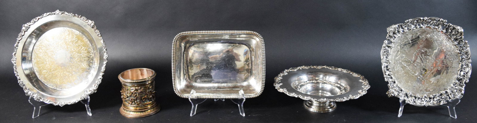 5 Silver-Plated and Metal Decorative Tableware Items: Five silver-plated and metal decorative tableware items. One round footed plate marked G.R. Collier & Co on the underside. One cylindrical cup or brush pot with a high-relief repouss?© scene, mar