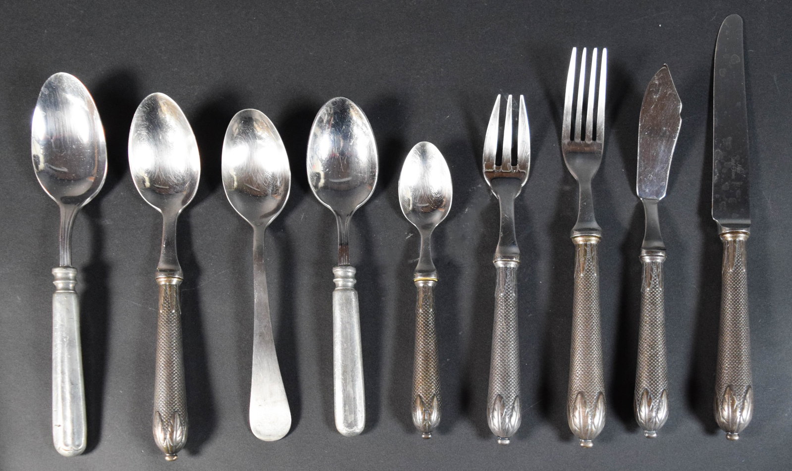 53-Piece Set of Alain Saint-Joanis French Flatware with Pewter Handles: 53 pieces of Alain Saint-Joanis French flatware. Collection includes dinner and dessert knives, forks, and spoons of multiple sizes, all contained within a wooden cutlery tray. Handle styles include a