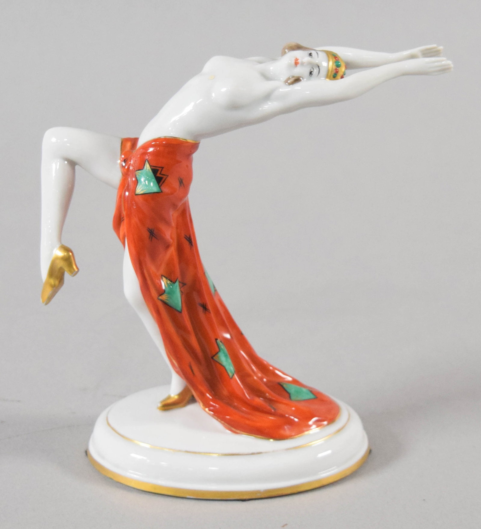 Galluba and Hofmann Art Deco Porcelain Showgirl Figurine: An Art Deco porcelain figurine of a female dancer or showgirl manufactured by Galluba and Hofmann. The underside of the white glazed base bears a green printed factory mark consisting of a crown above