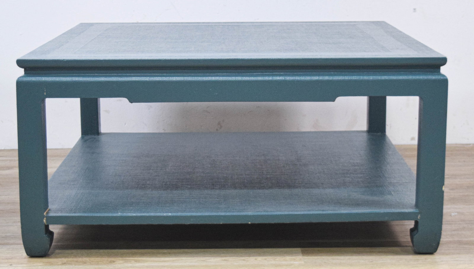 Chinoiserie Style Teal Blue Painted Square Coffee Table: Square Chinoiserie-style coffee table featuring a deep teal-blue painted finish. The design incorporates a full-width lower shelf supported by square legs that terminate in stylized, inward-curving ho