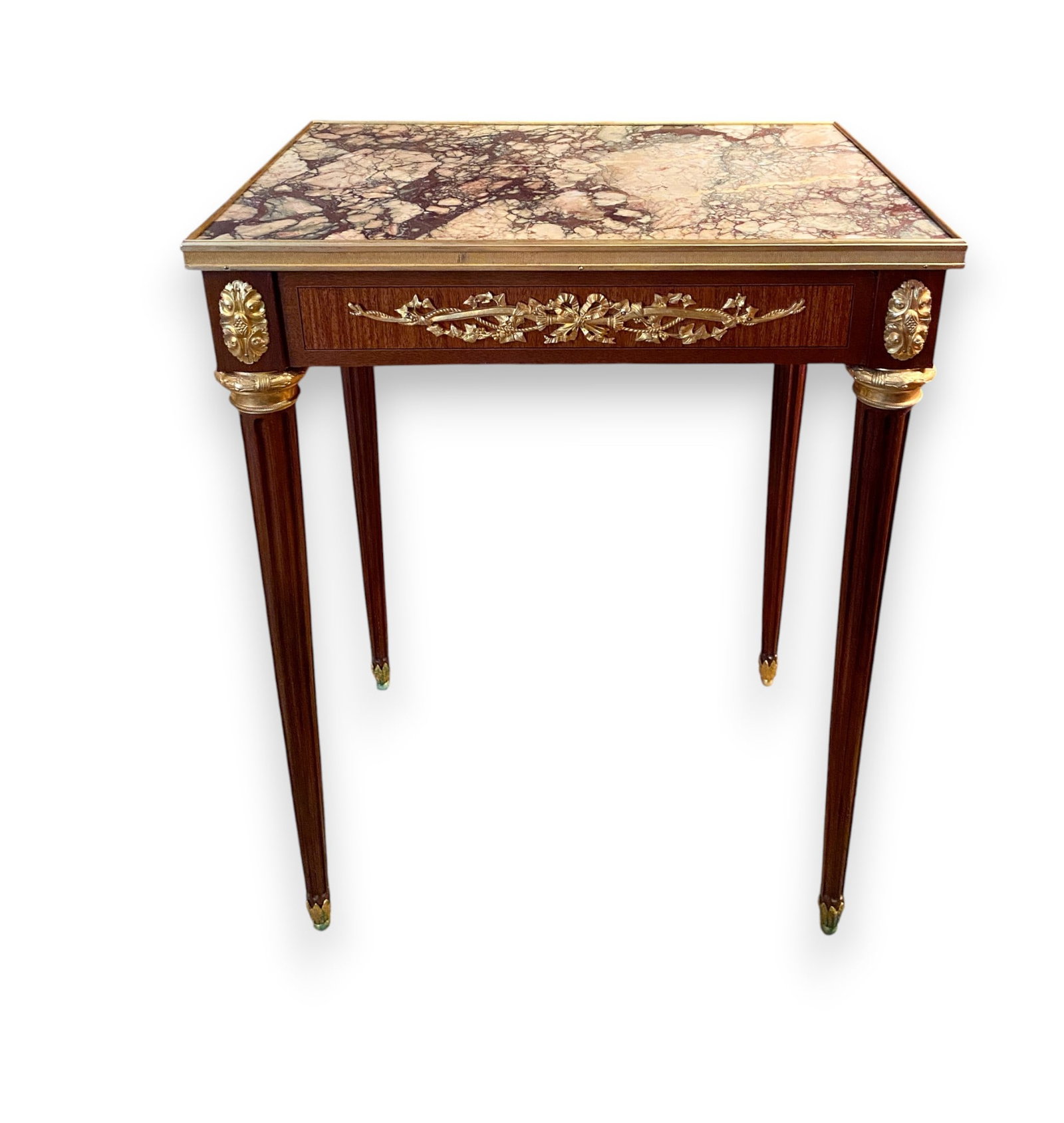Louis XVI Style Gilt Bronze Mounted Marble Top Mahogany End Table: A Louis XVI style end table featuring a wood frame with mahogany veneers. The rectangular inset brecciated marble top, showing purple, cream, and green tones, is set within a fluted gilt bronze galler