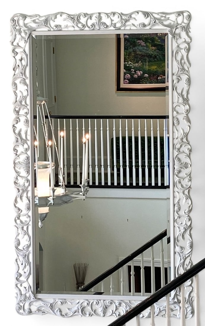 Large White Painted Ornate Rococo Style Beveled Wall Mirror: A large rectangular wall mirror featuring a pierced openwork frame in the Rococo style. The frame is decorated with repeating scrollwork, acanthus leaves, and C-scroll motifs, finished in a matte whit