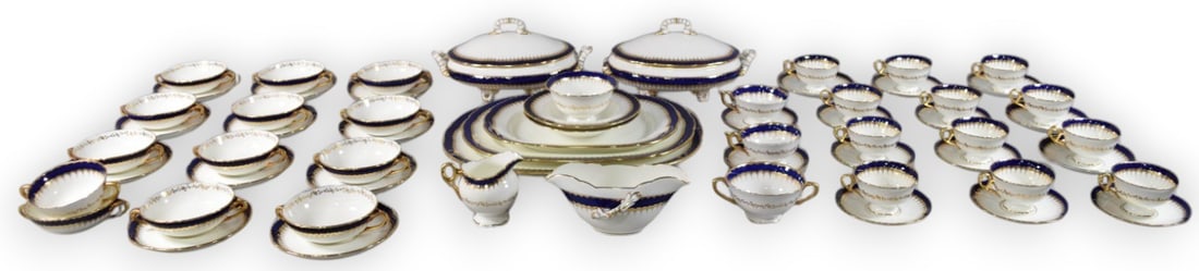 60+ Pieces of Coalport China (Spearpoint Pattern): 63 pieces of Coalport china in the Spearpoint pattern in cobalt blue with gilt trim. Service includes: 3 serving platters (largest 16 1/2? diameter), 2 lidded tureens (11 3/4?), 12 two-handled bouillo