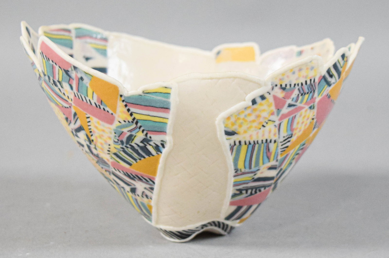 Curtis Benzle Inlay Porcelain Bowl: Curtis Benzle hand-built inlay porcelain bowl with an irregular scalloped rim. Signed Benzle on the underside of the base. 4 1/2" H x 7" W x 6" D.Location 39C