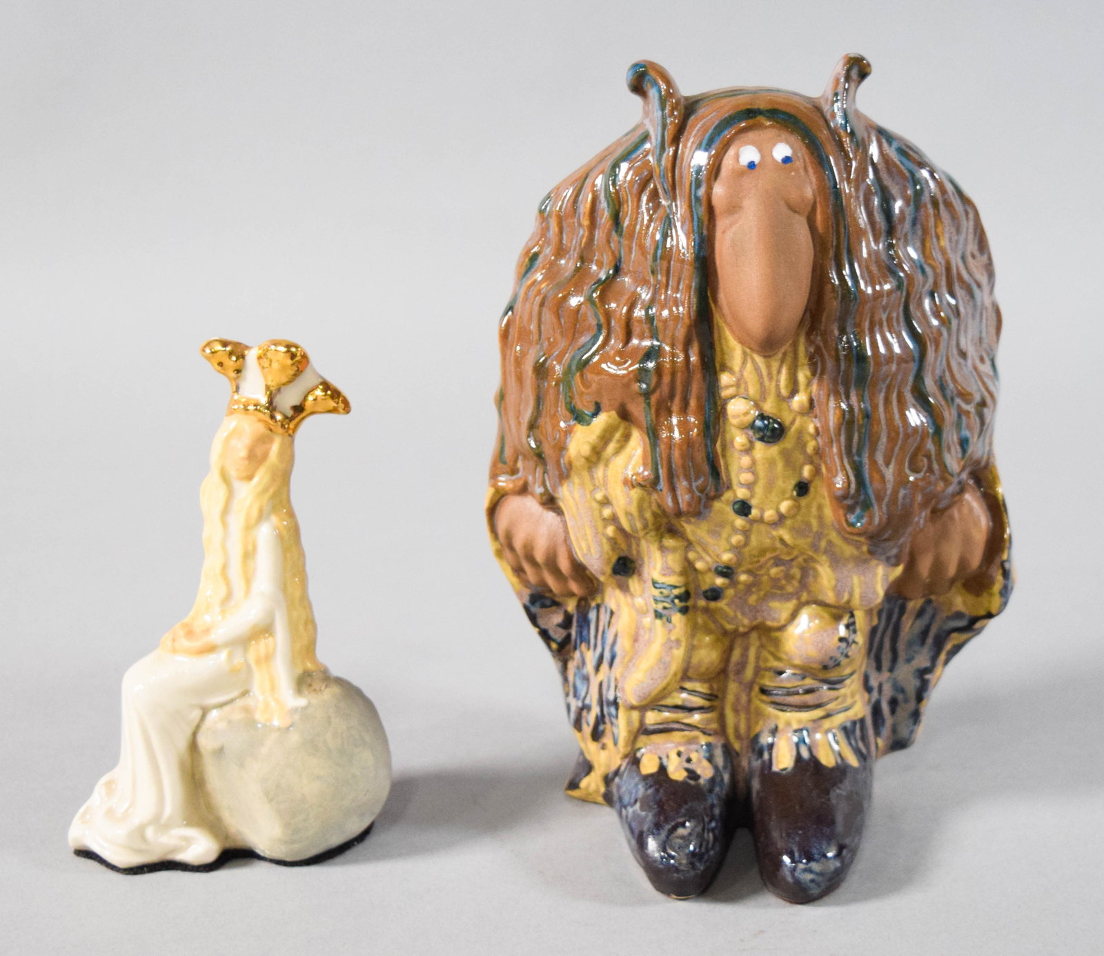 Two Rosa Ljung Swedish Glazed Ceramic Figurines: Two Rosa Ljung glazed ceramic figurines including a seated princess and a large troll. Both with adhesive labels reading Rosa Ljung's Original Svenskt Konsthantverk. Princess 5 1/2" H x 3 1/4" W x 2" 