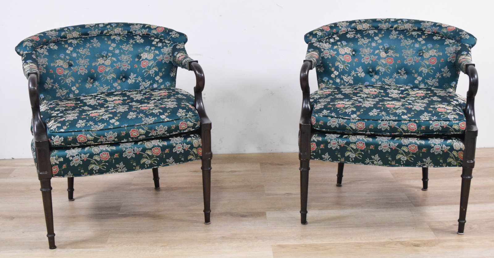 A Pair of Traditional Barrel-Back Open Armchairs with Floral Damask Upholstery: A pair of traditional barrel-back or tub-style open armchairs. The frames are constructed of dark-stained hardwood, featuring scrolled arms with upholstered pads and decorative green fringe trim at th