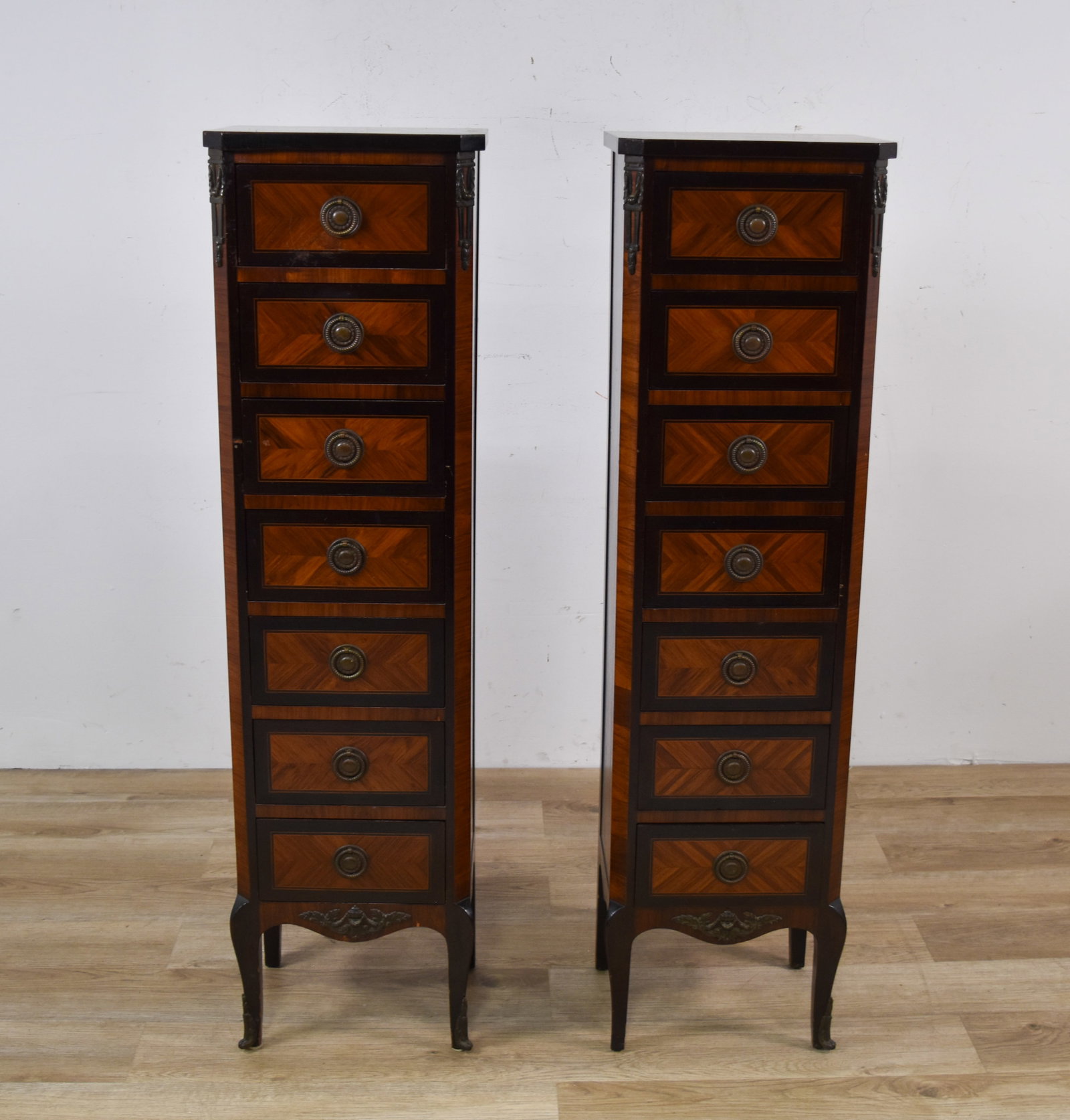 A Pair of John Widdicomb Parquetry Semainiers: A pair of John Widdicomb seven-drawer tall chests. The chests are designed in the Louis XV revival style, featuring mahogany and fruitwood veneers arranged in a book-matched geometric diamond parquetr