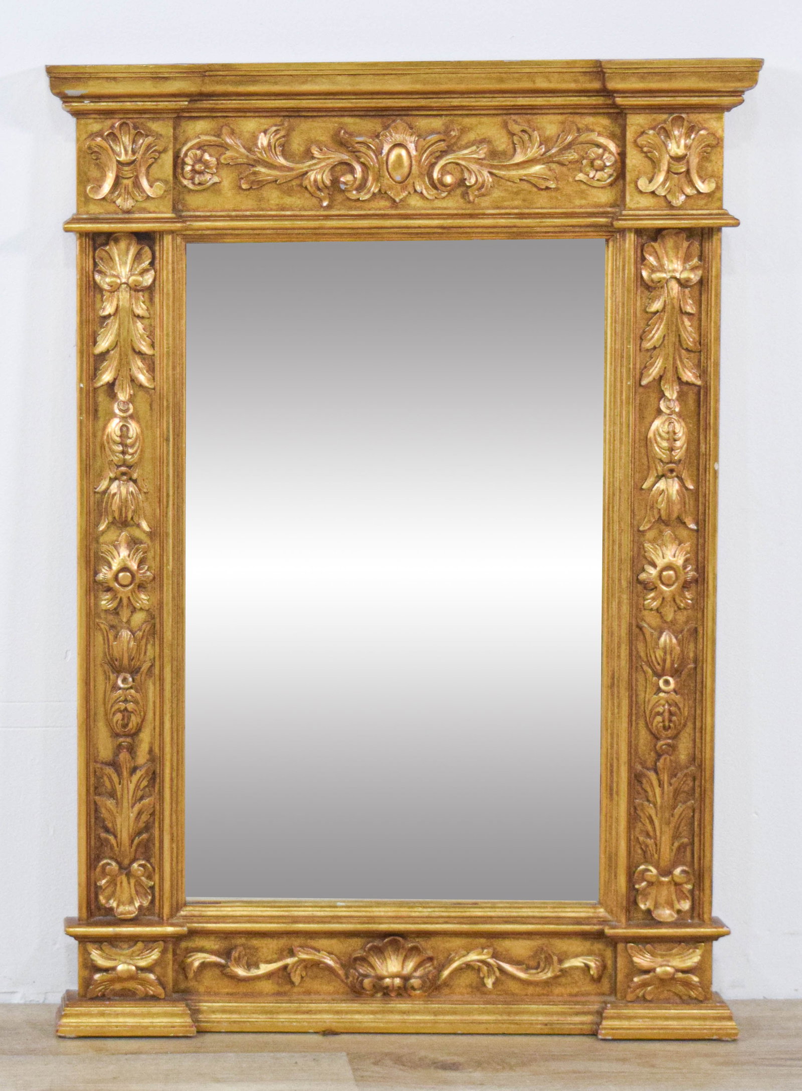 Anthony Amato Neoclassical Style Giltwood Pier Mirror: This Neoclassical style pier mirror features a hand-carved wood frame with a gilt finish over gesso, produced by artisan Anthony Amato. The design includes a stepped cornice top situated above a decor
