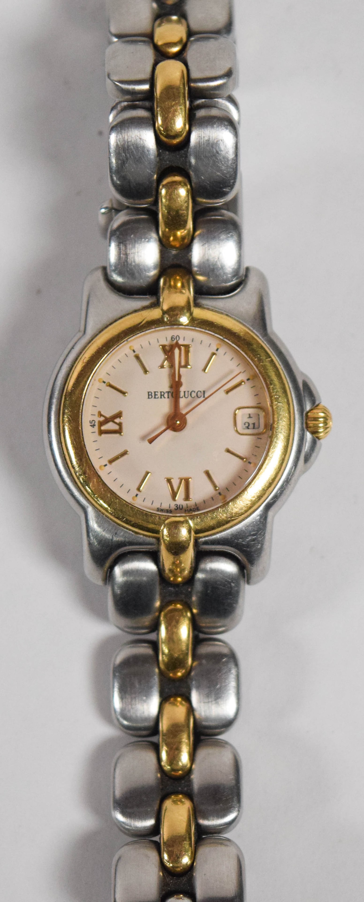 Bertolucci Pulchra Ladies Two-Tone Stainless Steel and Gold-Tone Wristwatch: This Bertolucci Pulchra ladies wristwatch features a two-tone design in stainless steel and yellow gold-tone metal. The round cream-colored dial includes gold-tone Roman numeral hour markers at the si