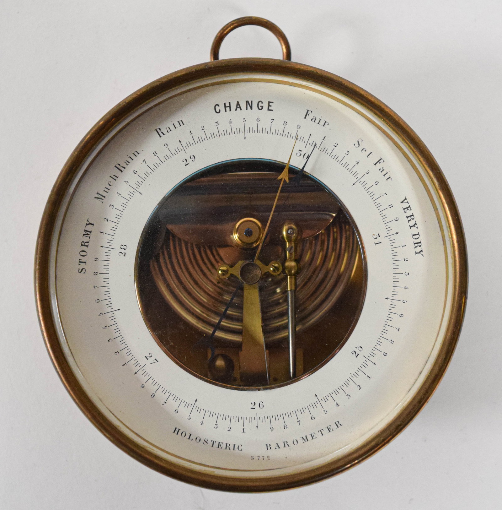 Naudet Holosteric Brass Barometer and Thermometer in Original Case: A large circular holosteric barometer and thermometer manufactured by Naudet, Pertuis, Hulot and Bourgeois. The instrument is encased in a polished brass housing with a top-mounted suspension ring and