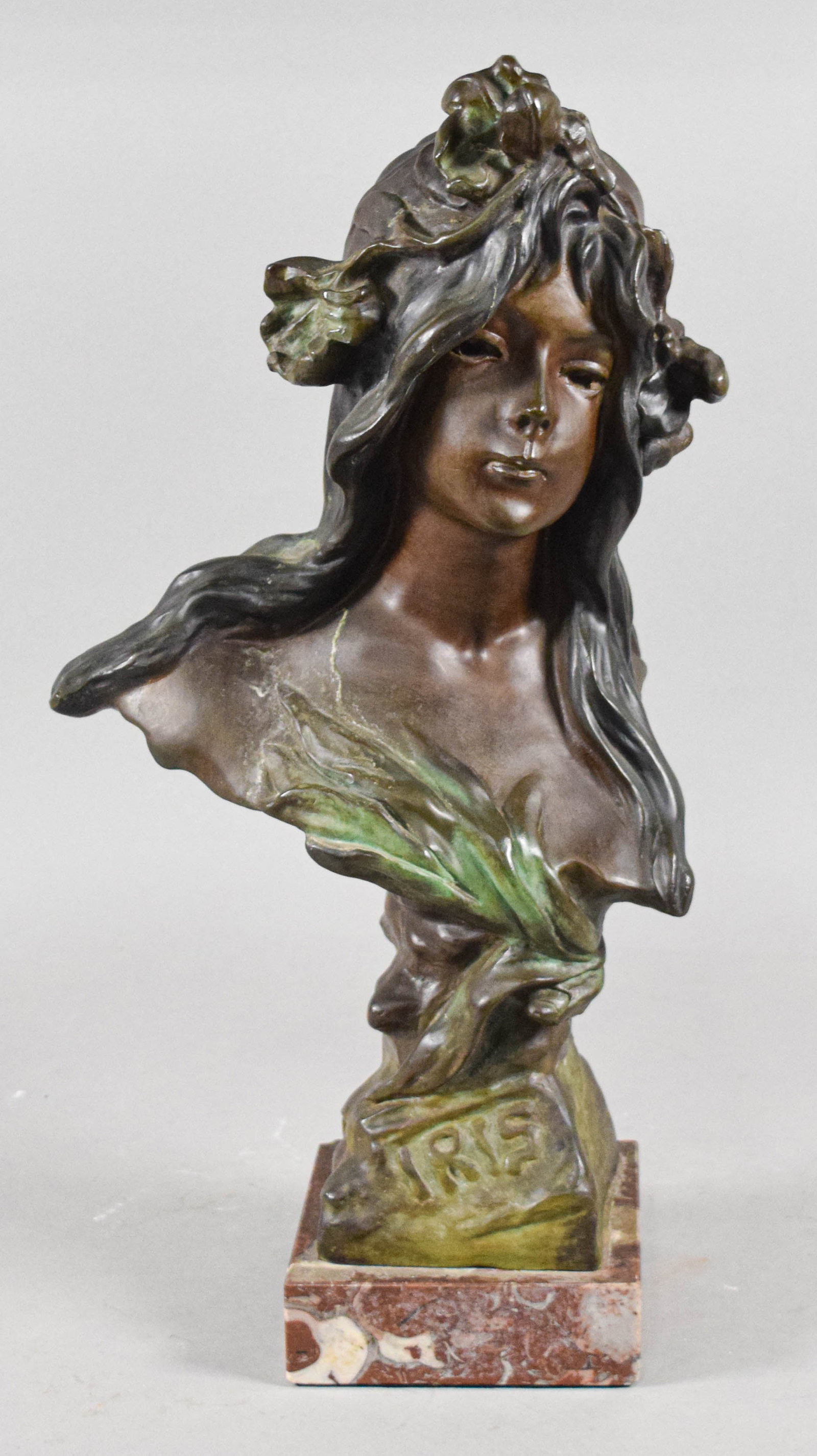 Emmanuel Villanis Art Nouveau Bronze Bust Iris: Emmanuel Villanis (French, 1858-1914). Art Nouveau bronze bust of a woman titled Iris. The bust is mounted on a separate, rectangular, polished reddish-brown variegated marble plinth. The work bears a