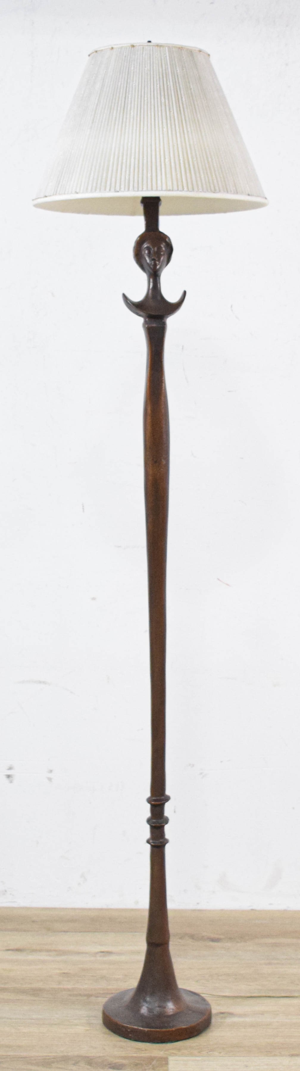After Alberto Giacometti Cast Resin Floor Lamp: After Alberto Giacometti figural floor lamp based on the T?te de Femme model. Cast resin simulating patinated bronze. The lamp is fitted with a two-socket cluster and independent pull-chain switches. 