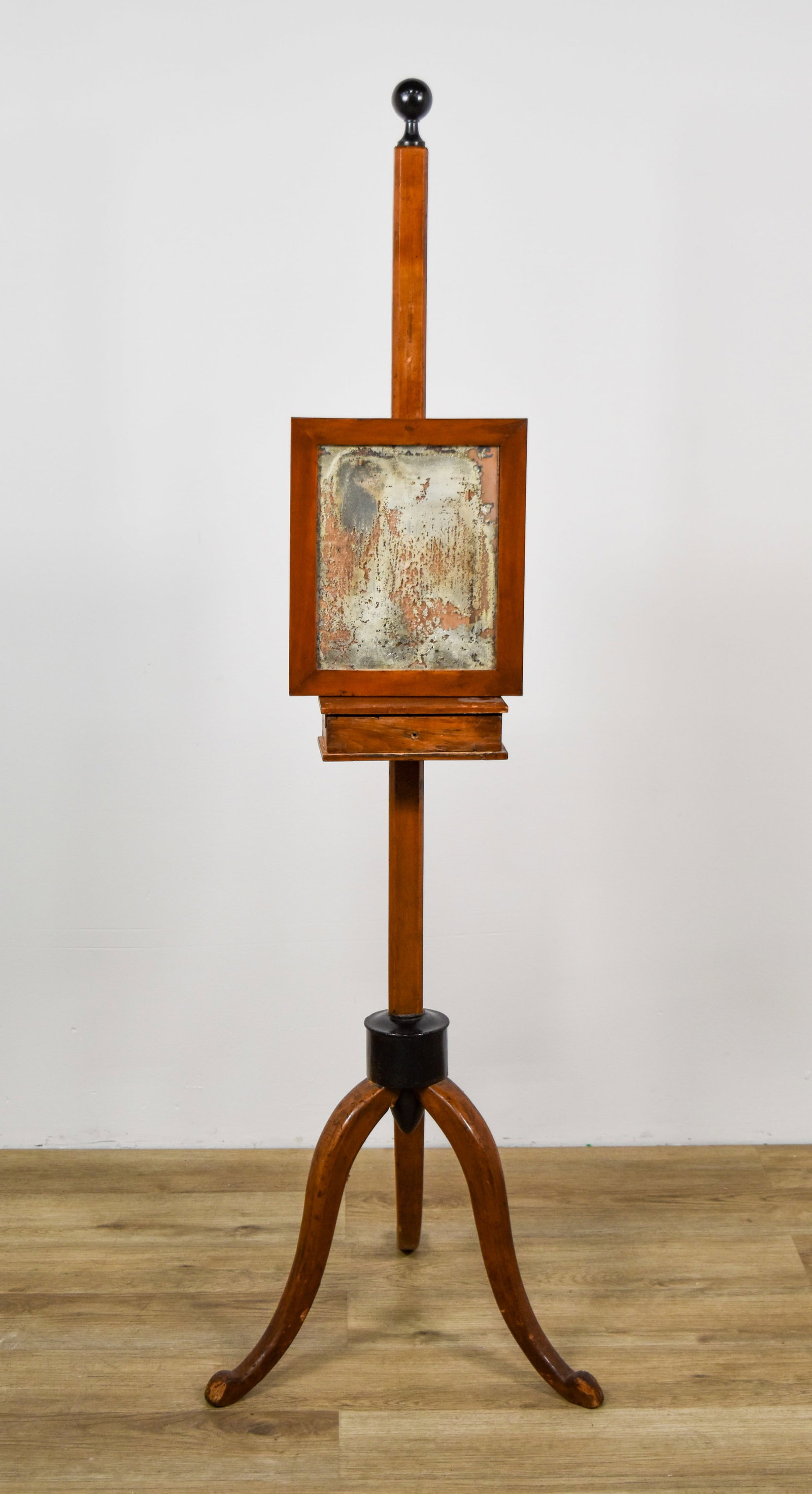 Vintage Hardwood Floor Standing Shaving Stand: This floor standing shaving stand is constructed from a warm-toned hardwood and features a central square-section post topped with a black-painted spherical finial. A rectangular framed mirror is moun
