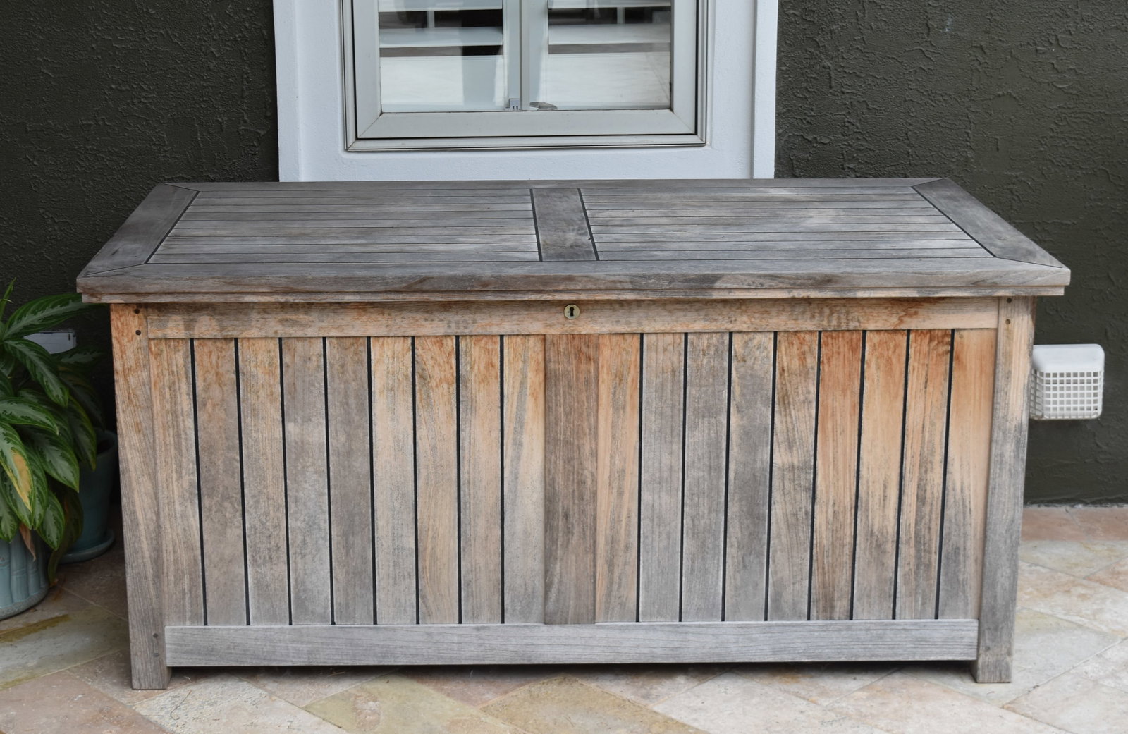 Barlow Tyrie Large Outdoor Teak Storage Chest: Barlow Tyrie large outdoor teak storage chest. The lid is mounted on internal hinges and features two black gas struts designed to assist in opening and soft closing. A brass escutcheon on the front p