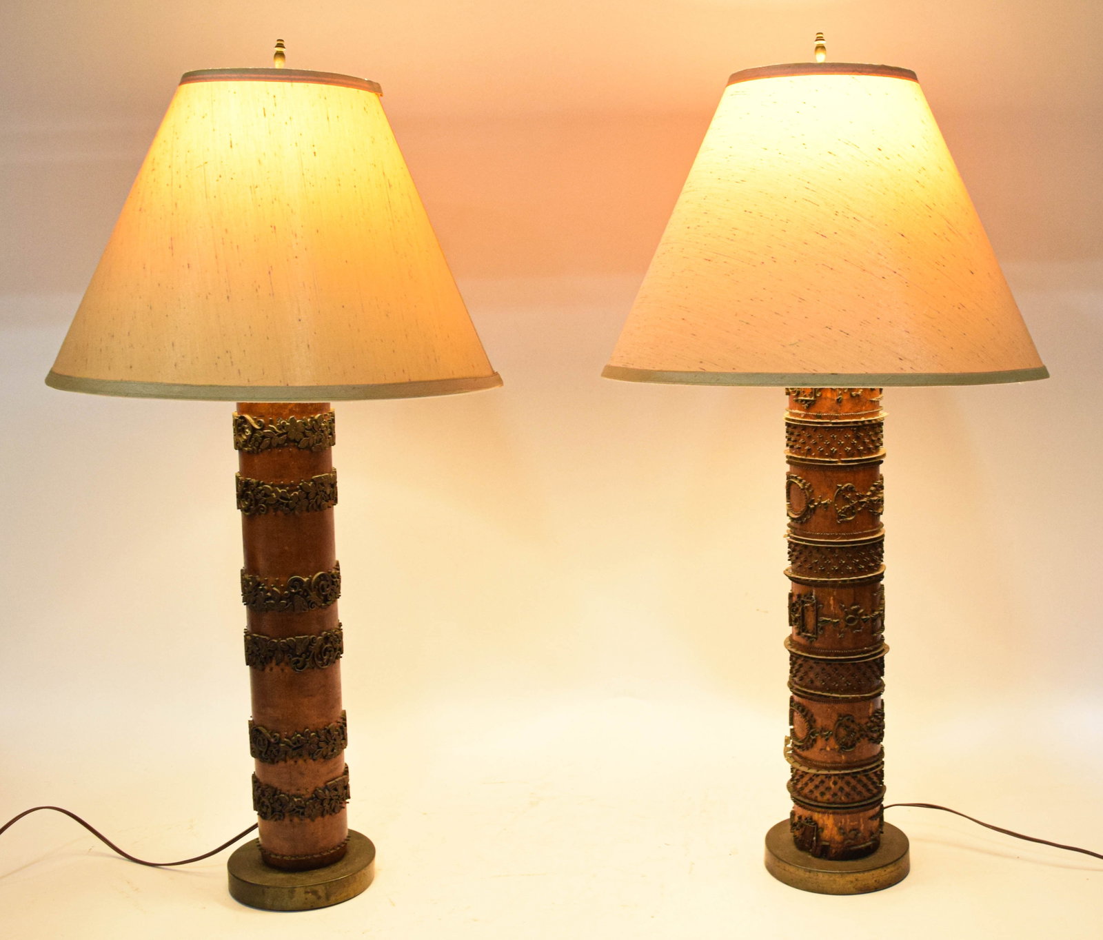 Near Pair of Industrial Printing Roller Table Lamps: Near pair of industrial style table lamps constructed from repurposed antique printing rollers. The bases utilize salvaged wood cores with intricate metal ornamentation. The lamps feature contrasting 