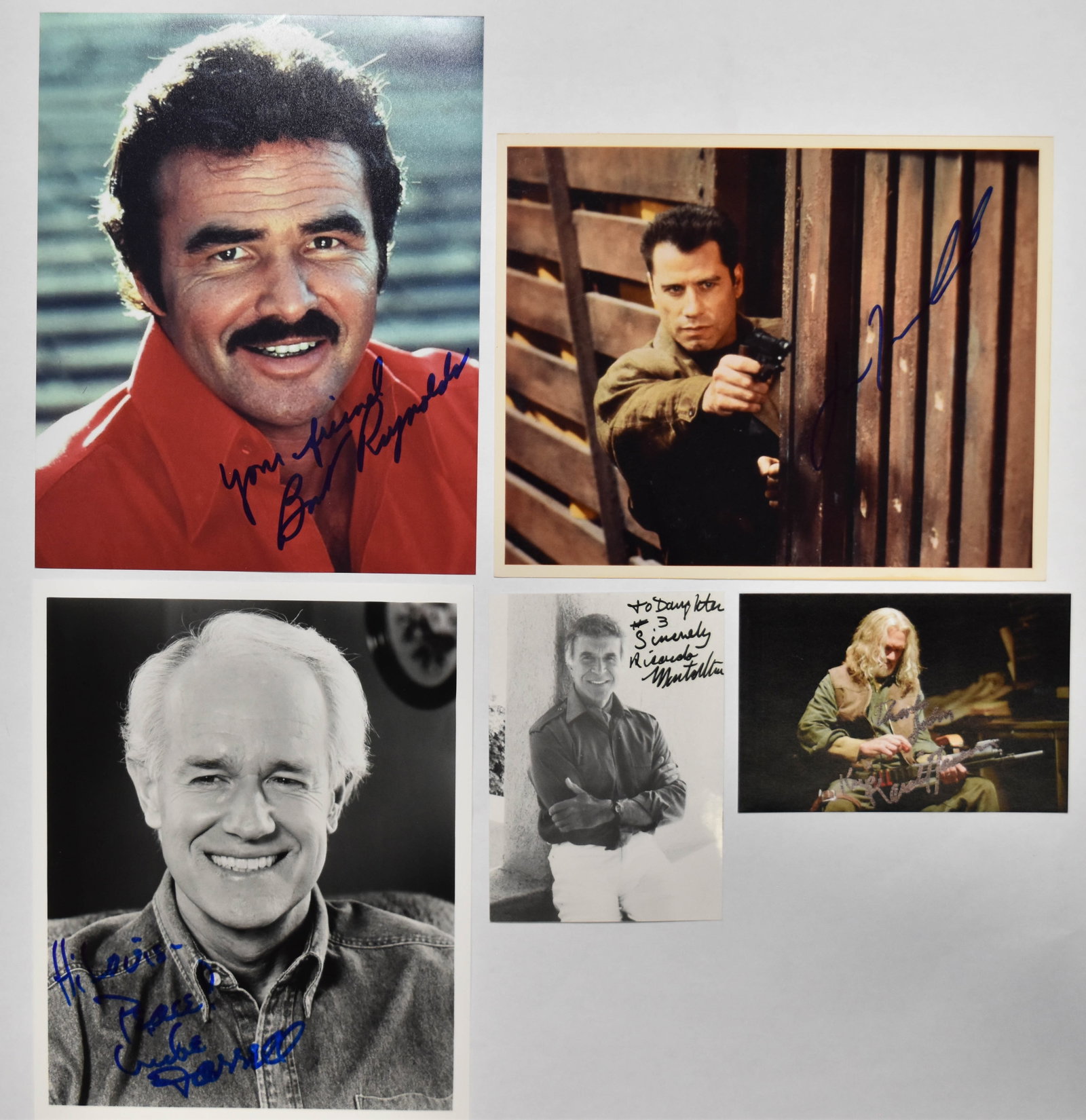5 Burt Reynolds John Travolta and Kris Kristofferson Signed Promotional Photographs: Five signed publicity and character photographs of various American and Mexican actors. Burt Reynolds (American, 1936-2018) is featured in an 8x10-inch color satin-finish portrait wearing a red shirt.