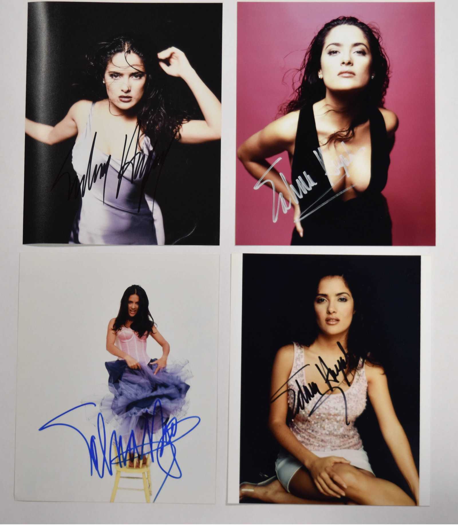 4 Autographed Color Photographs of Salma Hayek with COA: A collection of 4 autographed color photographs of actress Salma Hayek. The group features Hayek in various poses, with each photograph hand-signed in a different medium. The first photograph shows Ha