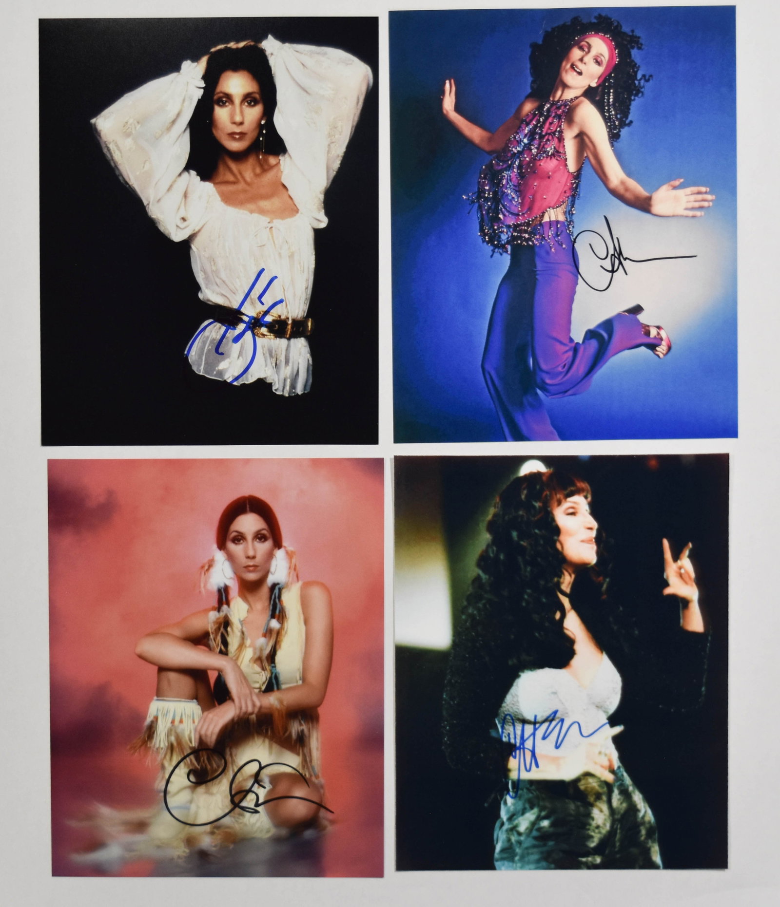 4 Autographed Cher Photographs with COA: This lot features four color photographs, each measuring 8 inches by 10 inches and individually autographed by the entertainer Cher. The collection includes images depicting different eras and styles 