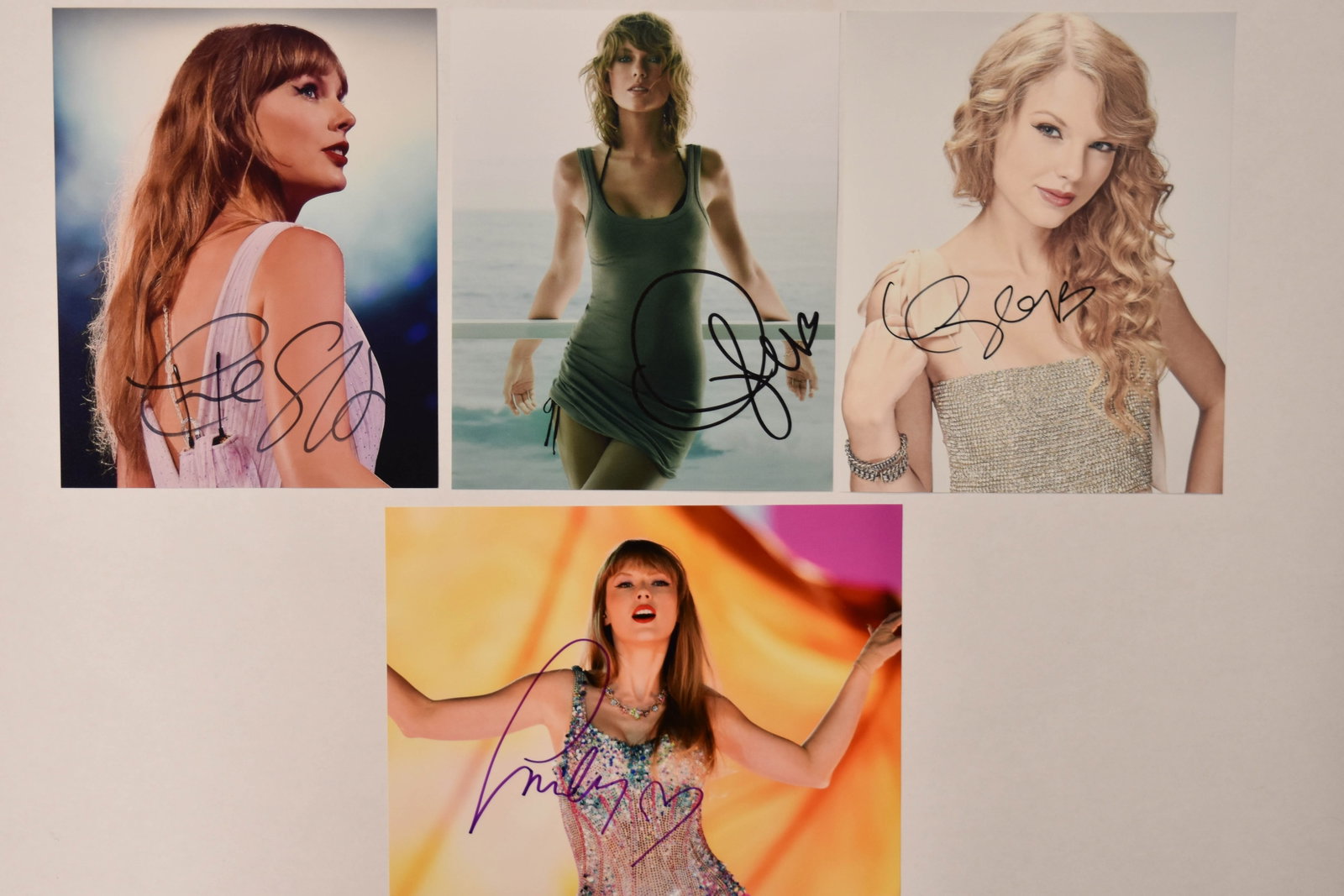 4 Taylor Swift Signed Color Photographs Taylor Swift: Taylor Swift (American, b. 1989). Four color photographs, Taylor Swift portraits and stage performances. The collection features the artist in a variety of professional poses and costumes spanning sev