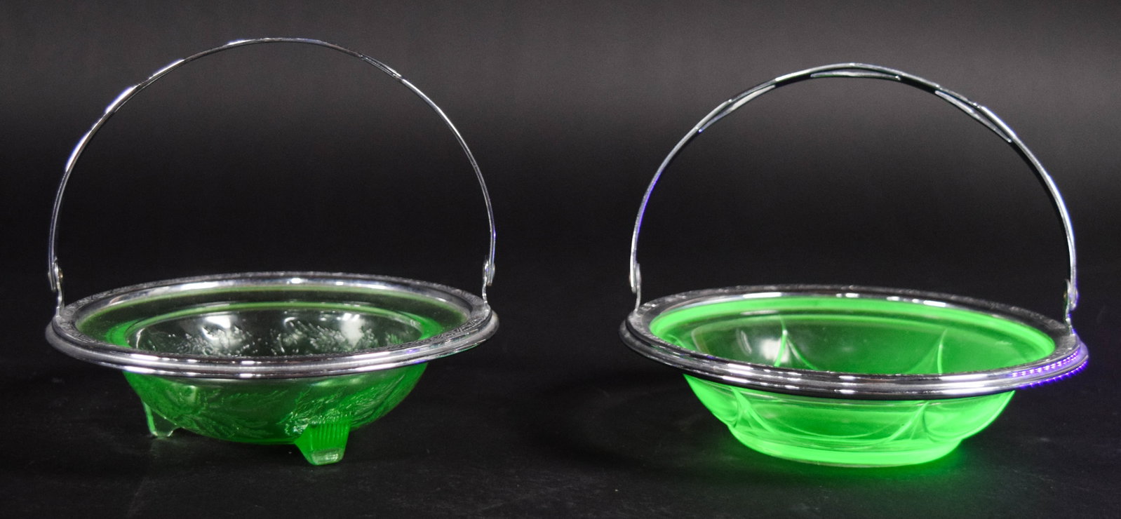 2 Pressed Green Uranium Glass Dishes in Silver-Plated Mounts: Two pressed green uranium glass dishes mounted in silver-plated basket frames. The glass demonstrates a vibrant green color that fluoresces under ultraviolet light. The group includes a three-footed d