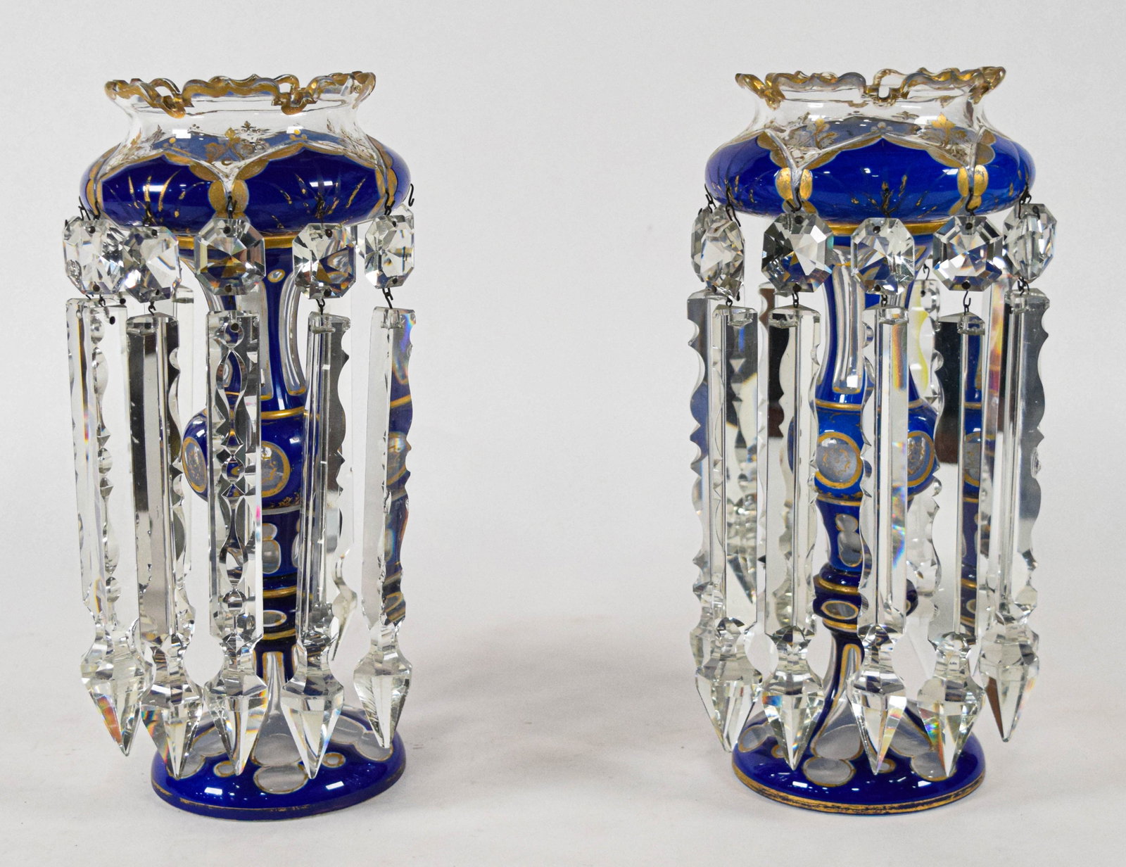 Pair of Bohemian Cobalt Blue Overlay Glass Lustres: Pair of Bohemian cobalt blue overlay glass lustres, late 19th or early 20th century. The lustres feature flared, scalloped rim bowls supported by baluster stems on circular bases. The cobalt blue glas