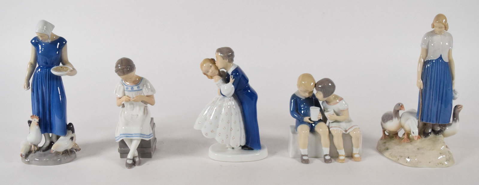 Group of 5 Bing & Grondahl Porcelain Figurines: Group of five Bing & Grondahl porcelain figurines featuring traditional Danish genre scenes, including two works by sculptor Axel Locher (Danish, 1879-1941). Each piece is decorated in a traditional u