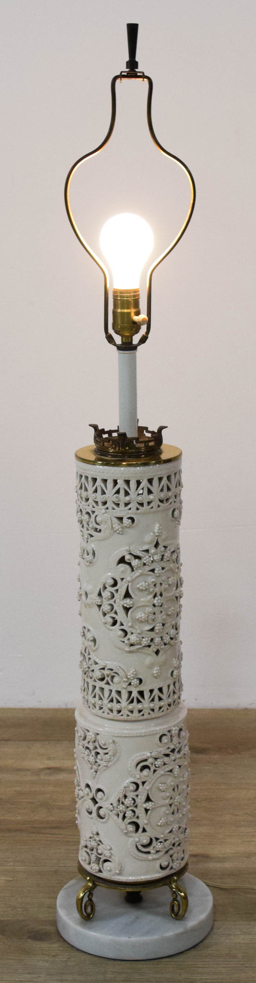 Large Reticulated Blanc de Chine Porcelain Table Lamp Base: A tall, cylindrical table lamp featuring a white glazed porcelain body. The porcelain is decorated with elaborate reticulated lattice work and applied high-relief grape and vine floral motifs. The lam